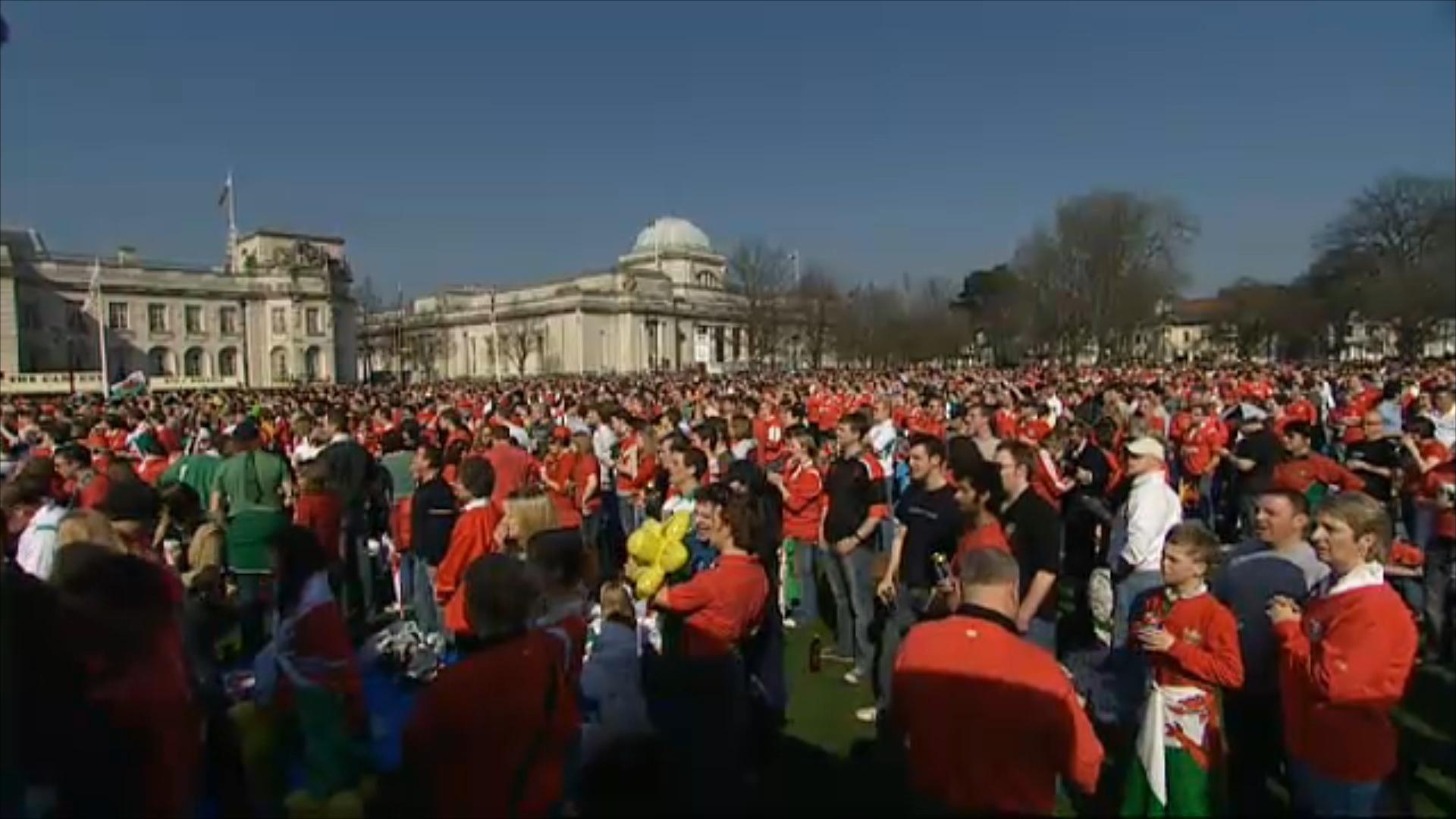 Crowds of people wearing red Wales jerseys outside the National Museum in Cardiff