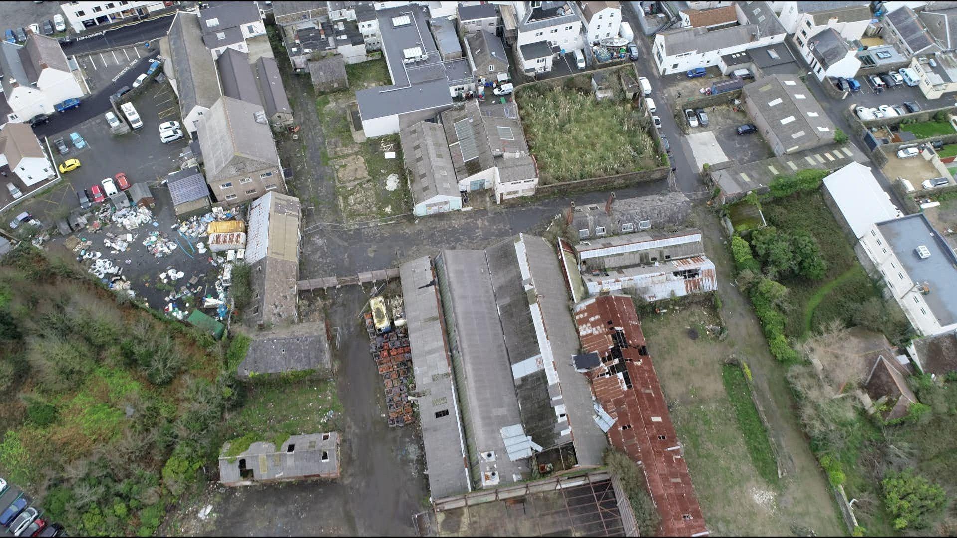 A derelict site containing lots of industrial buildings, pictured from the air. 