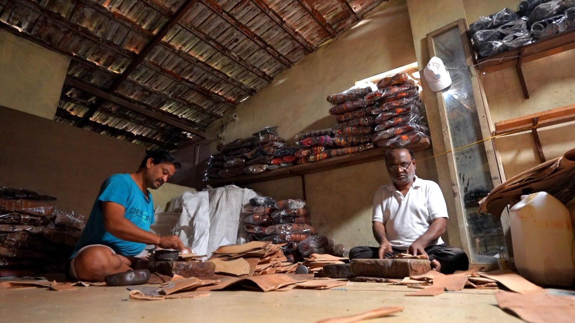 Two artisans make leather sandals at their workshop in Kolhapur, Maharashtra