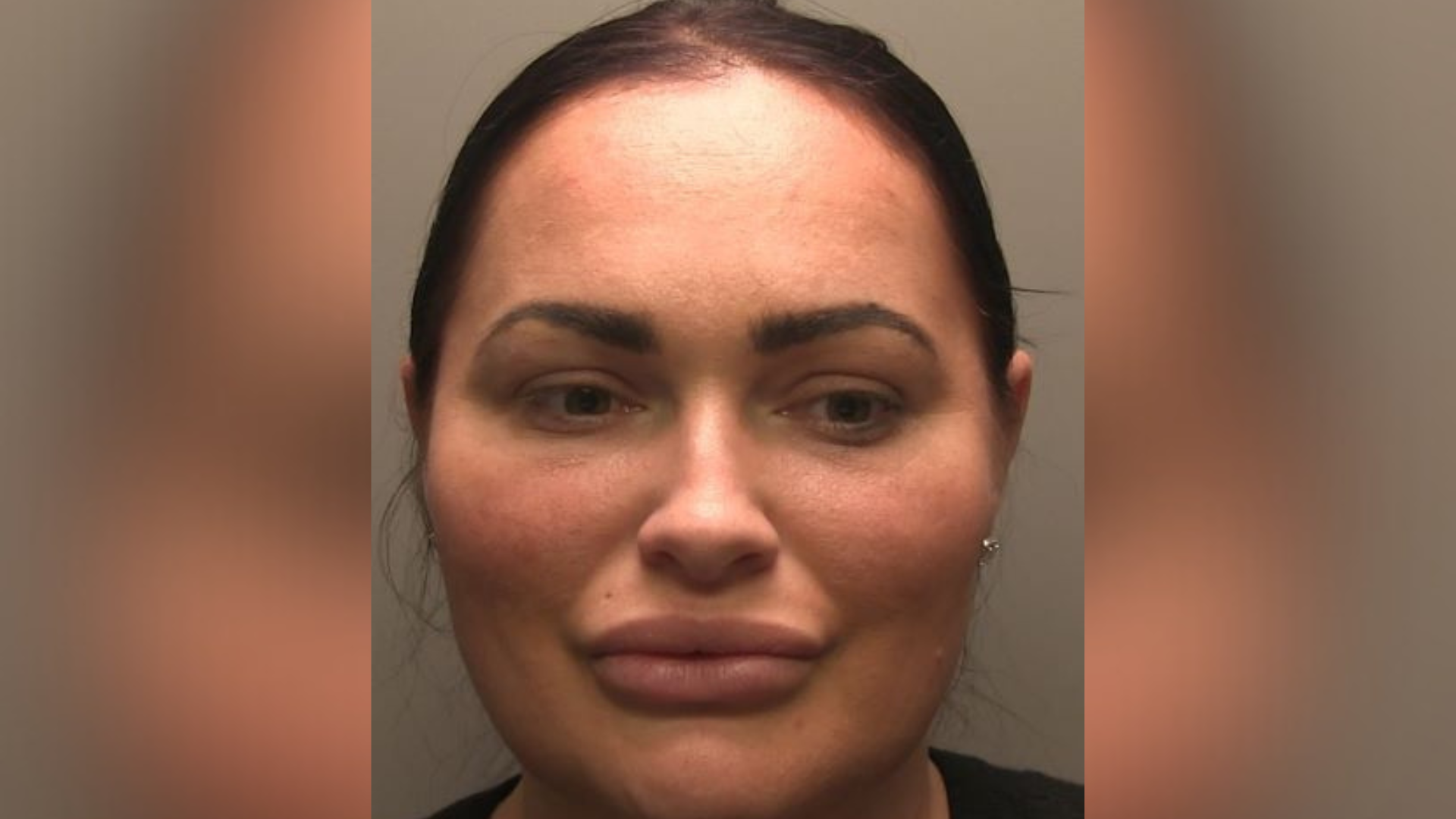 Police custody picture of Natasha Allarakhia. She has black hair tied back.