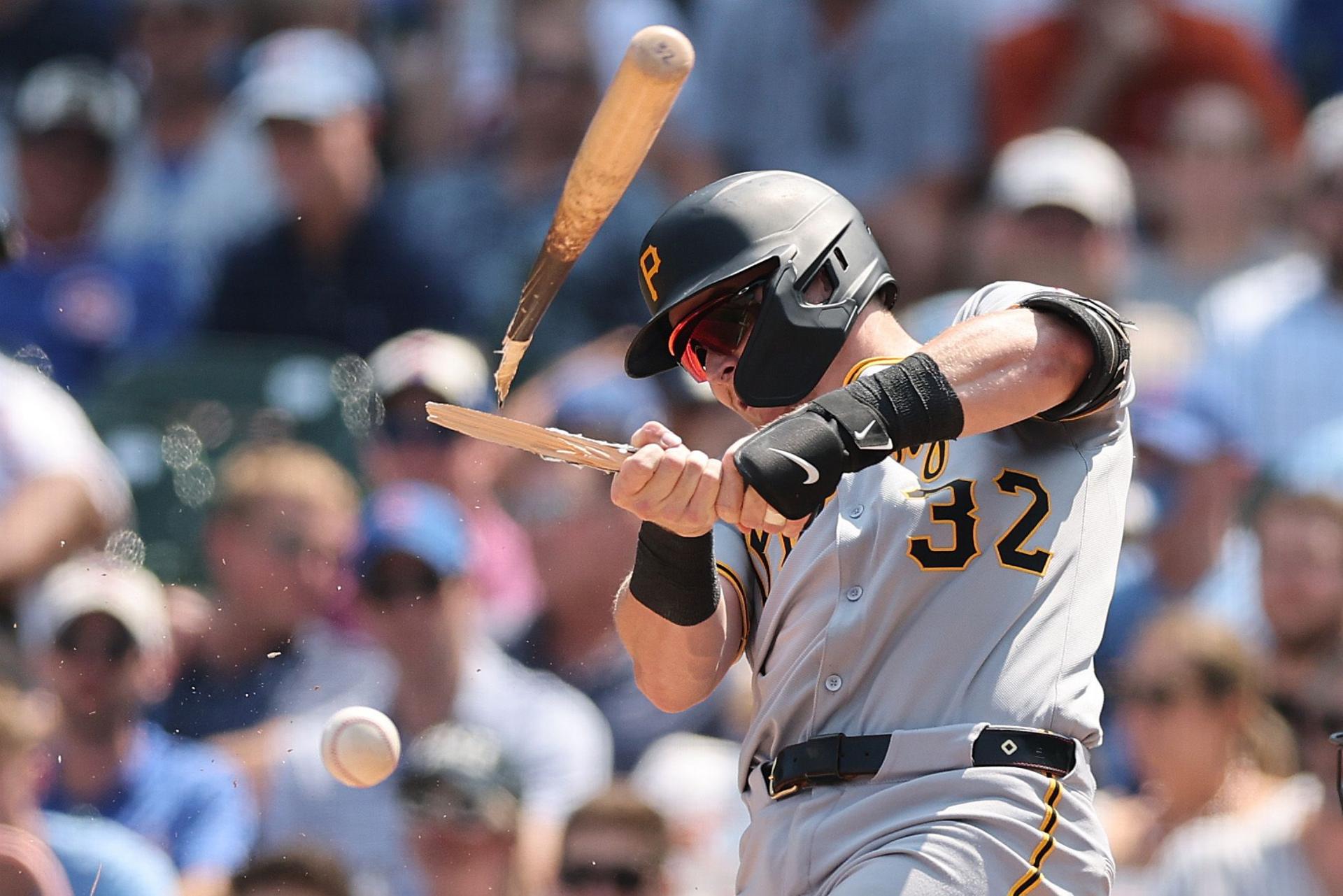 Henry Davis of the Pittsburgh Pirates breaks his bat as he hits the ball against the Chicago Cubs in the MLB at Wrigley Field in Chicago