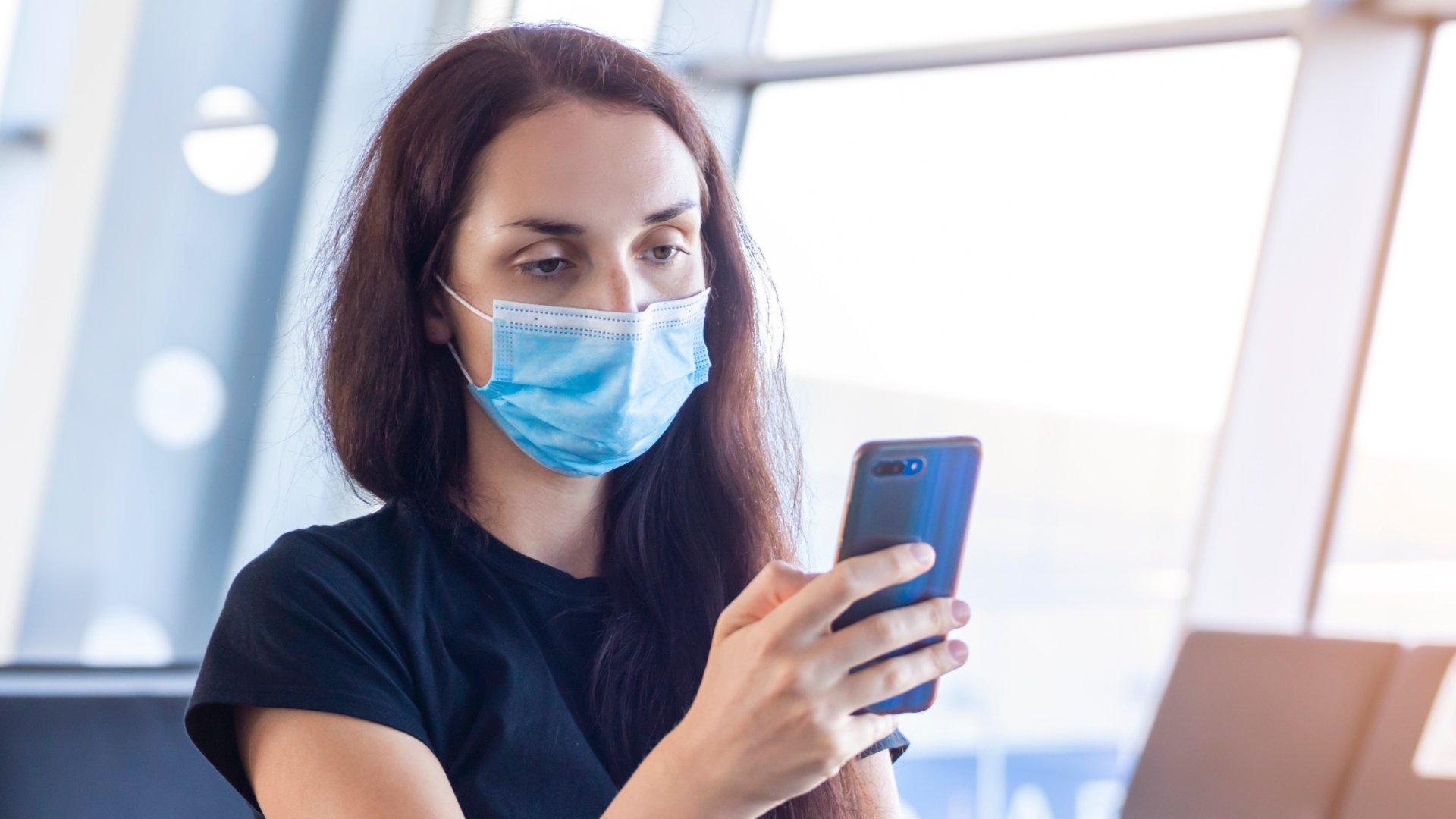 Woman holding a phone in an airport