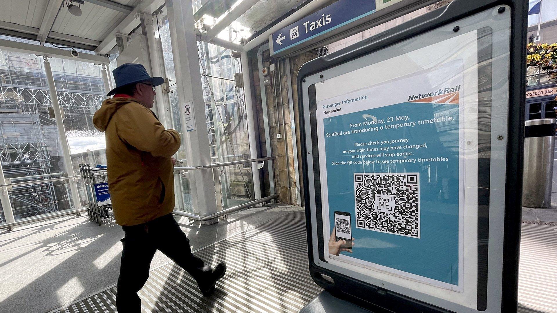 man beside timetable sign