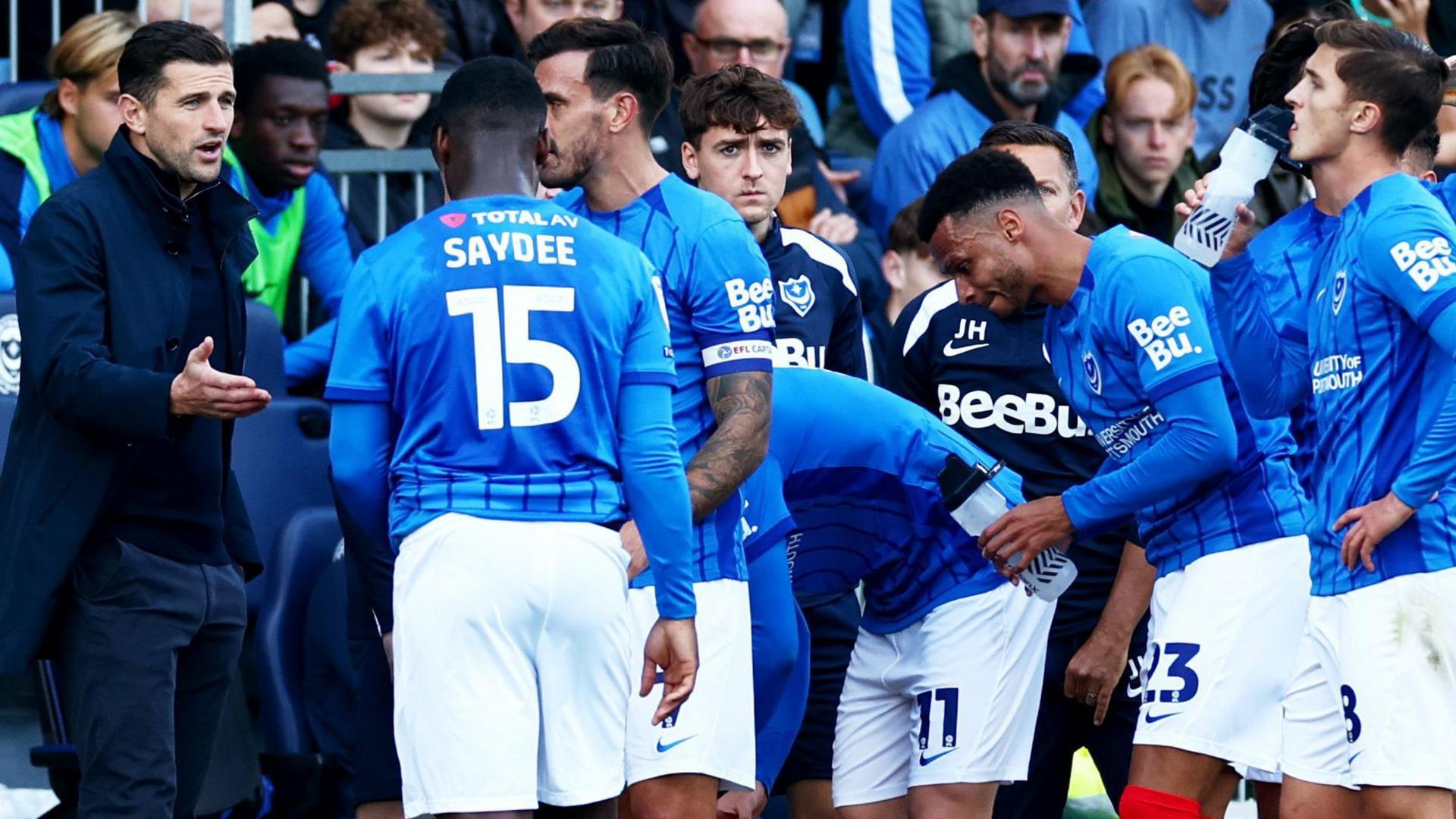 John Mousinho with his Portsmouth players during the match against Oxford United