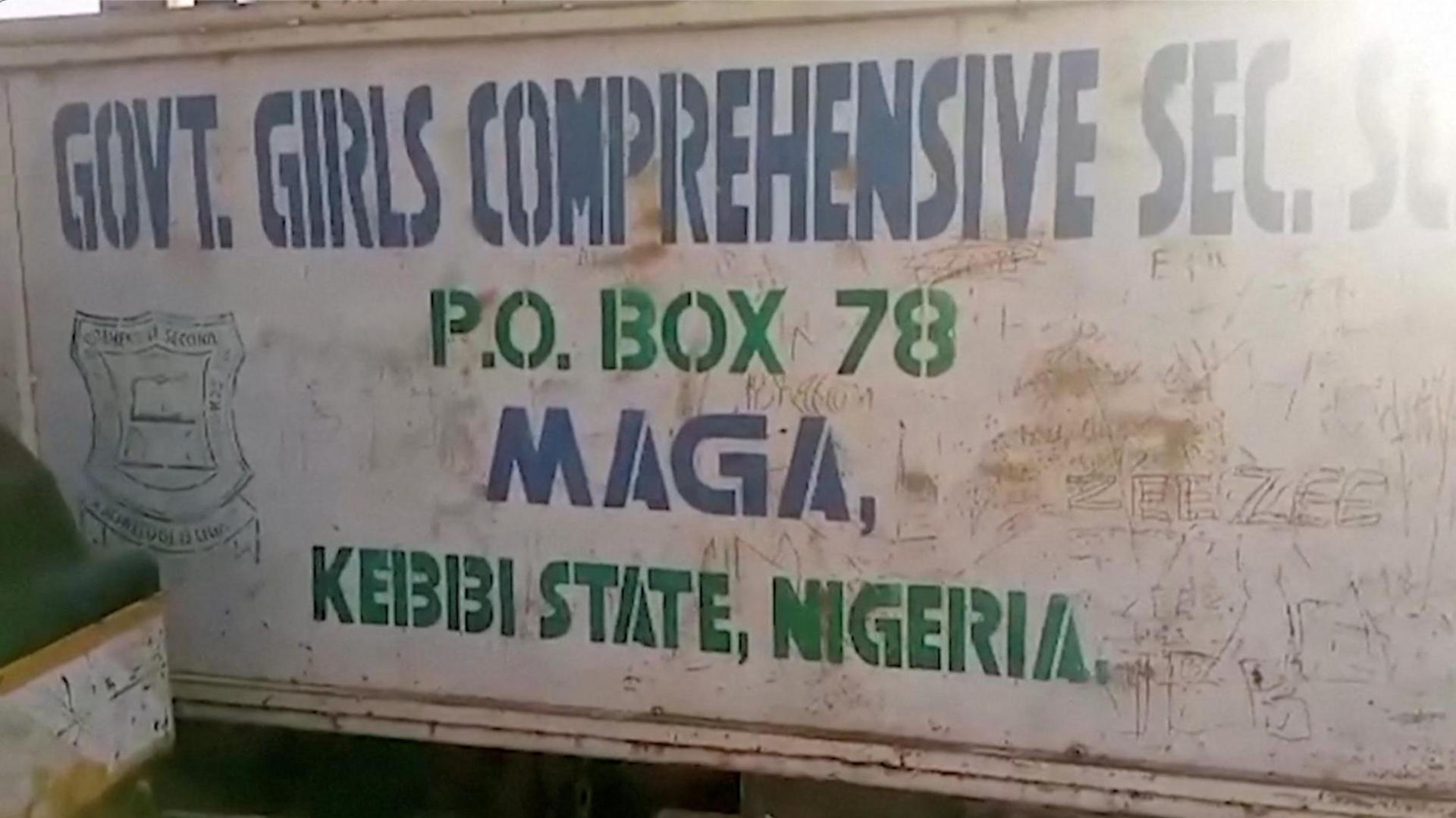 A school sign is shown reading: "Govt. Girls Comprehensive Sec. School."