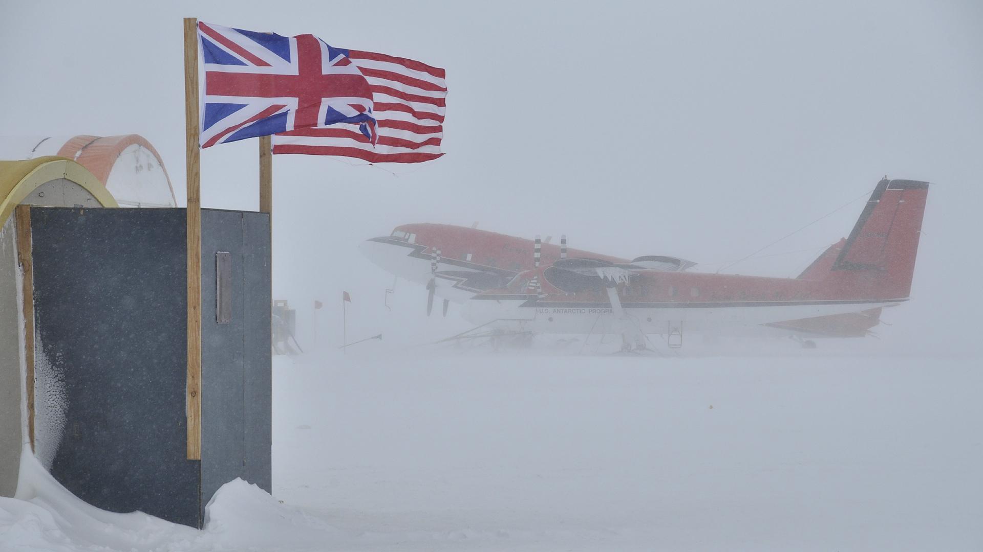 Plane seen through a blizzard on the ground