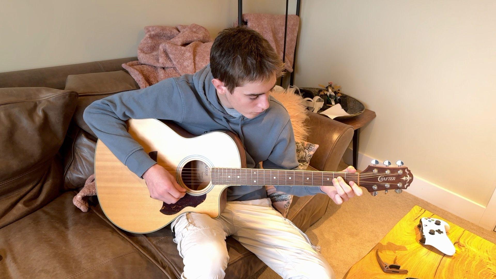 Finley aged 15 playing his guitar