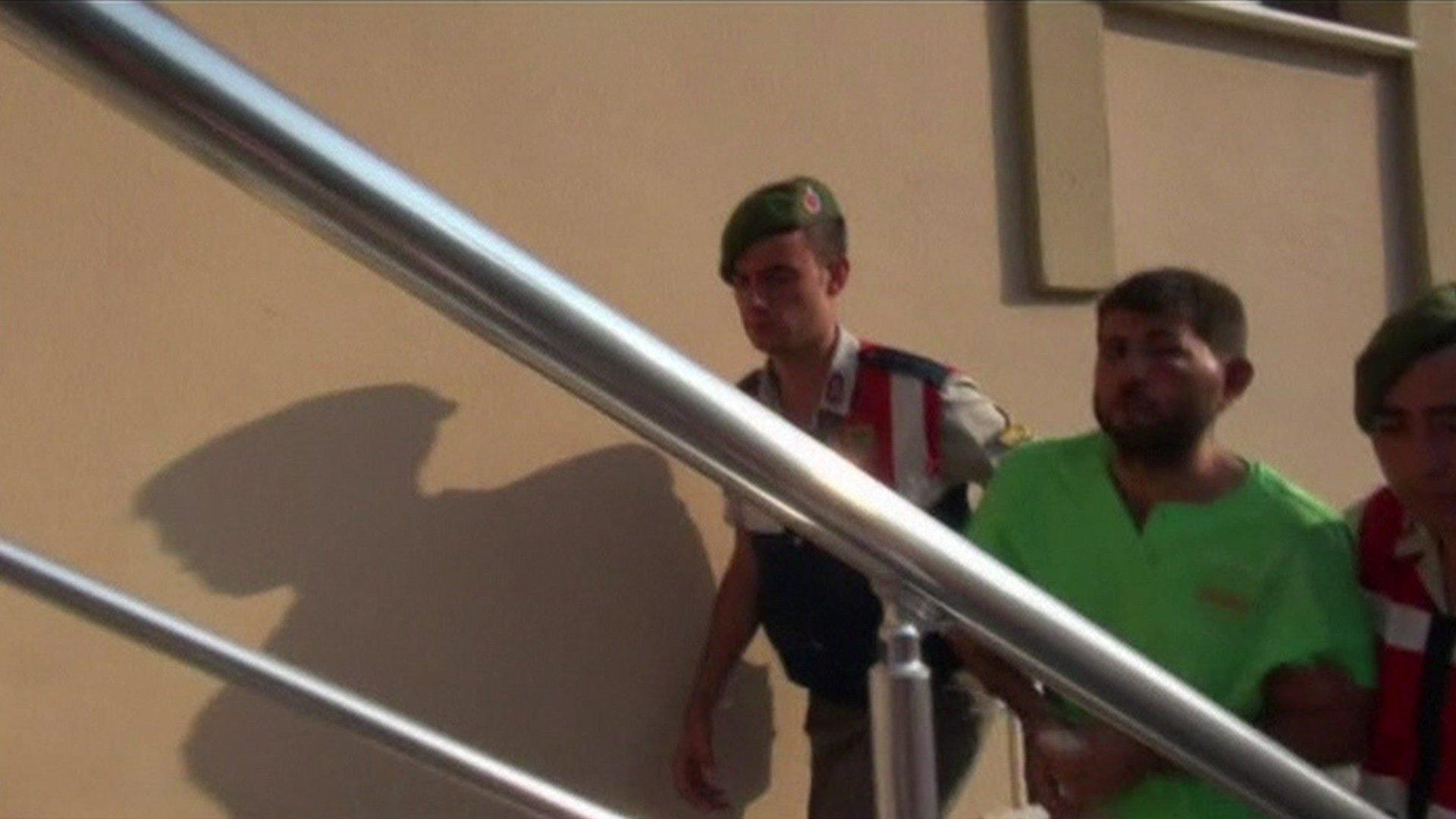 Turkish security forces escorting Captain Mustafa Serdar Ozay into police station (1 August 2016)