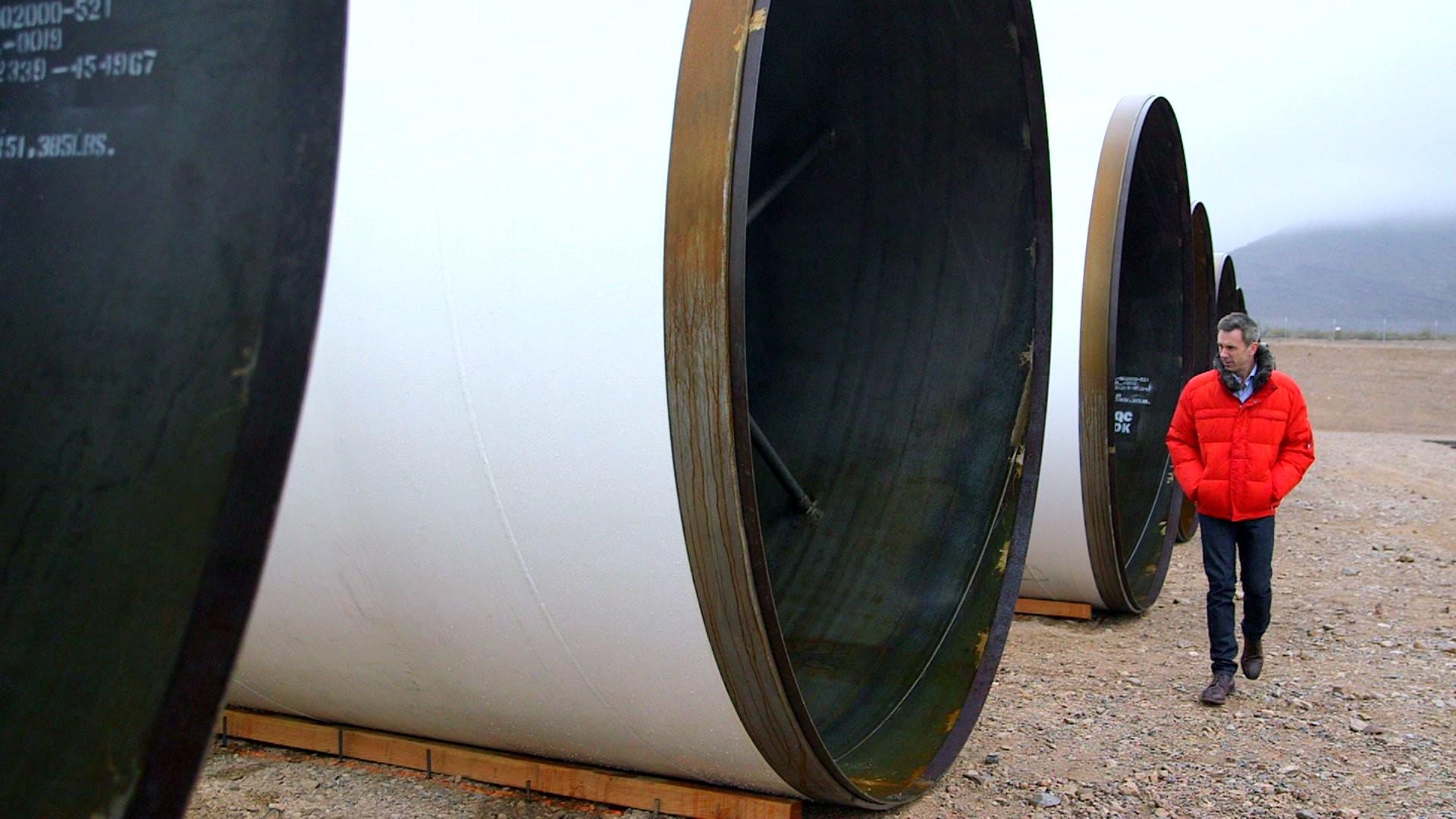 Spencer Kelly stands next to Hyperloop tubes