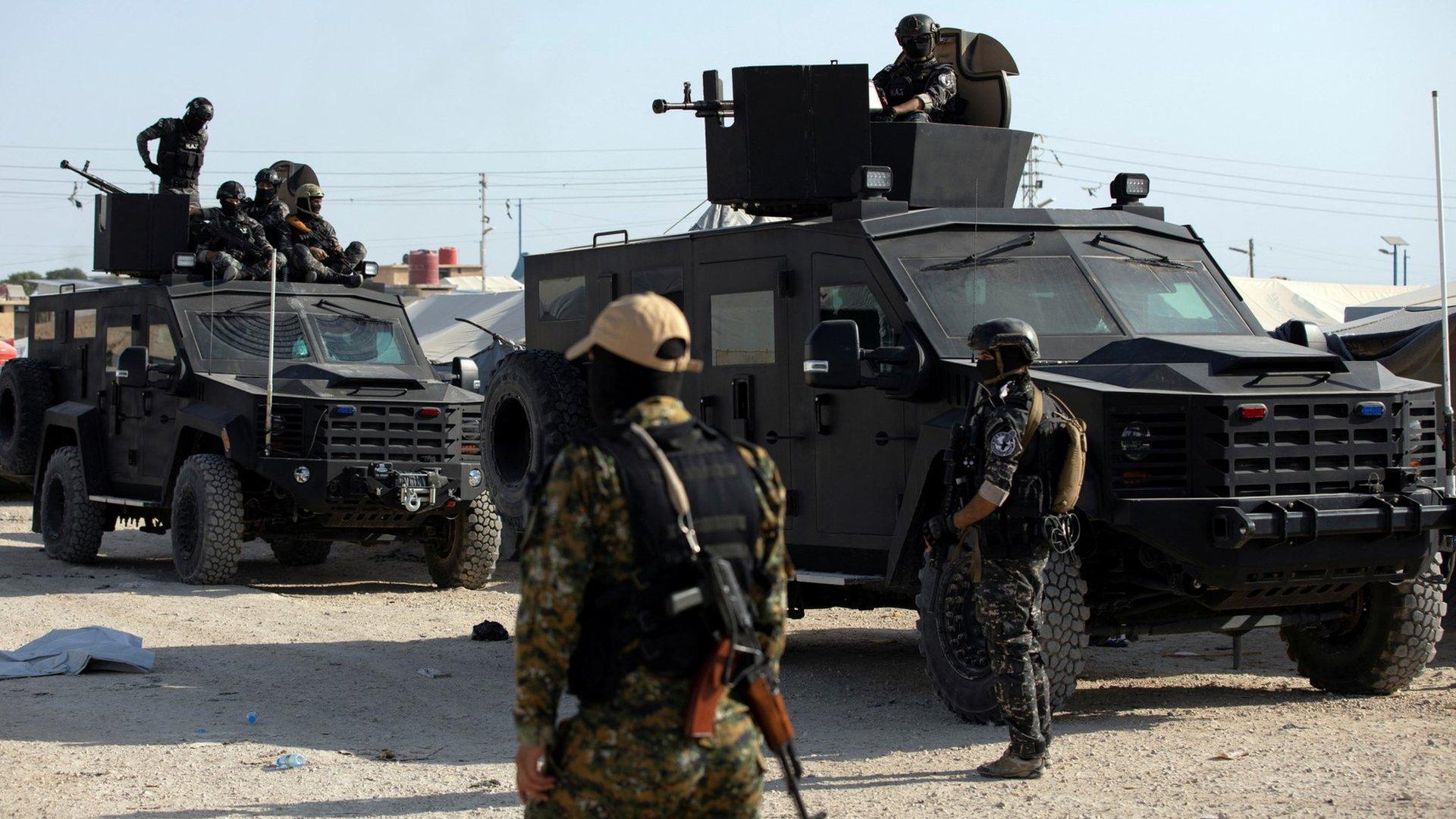 File photo showing a Syrian Democratic Forces (SDF) fighter stands near Kurdish internal security special forces during a security operation in al-Hol camp, in north-east Syria (26 August 2022)