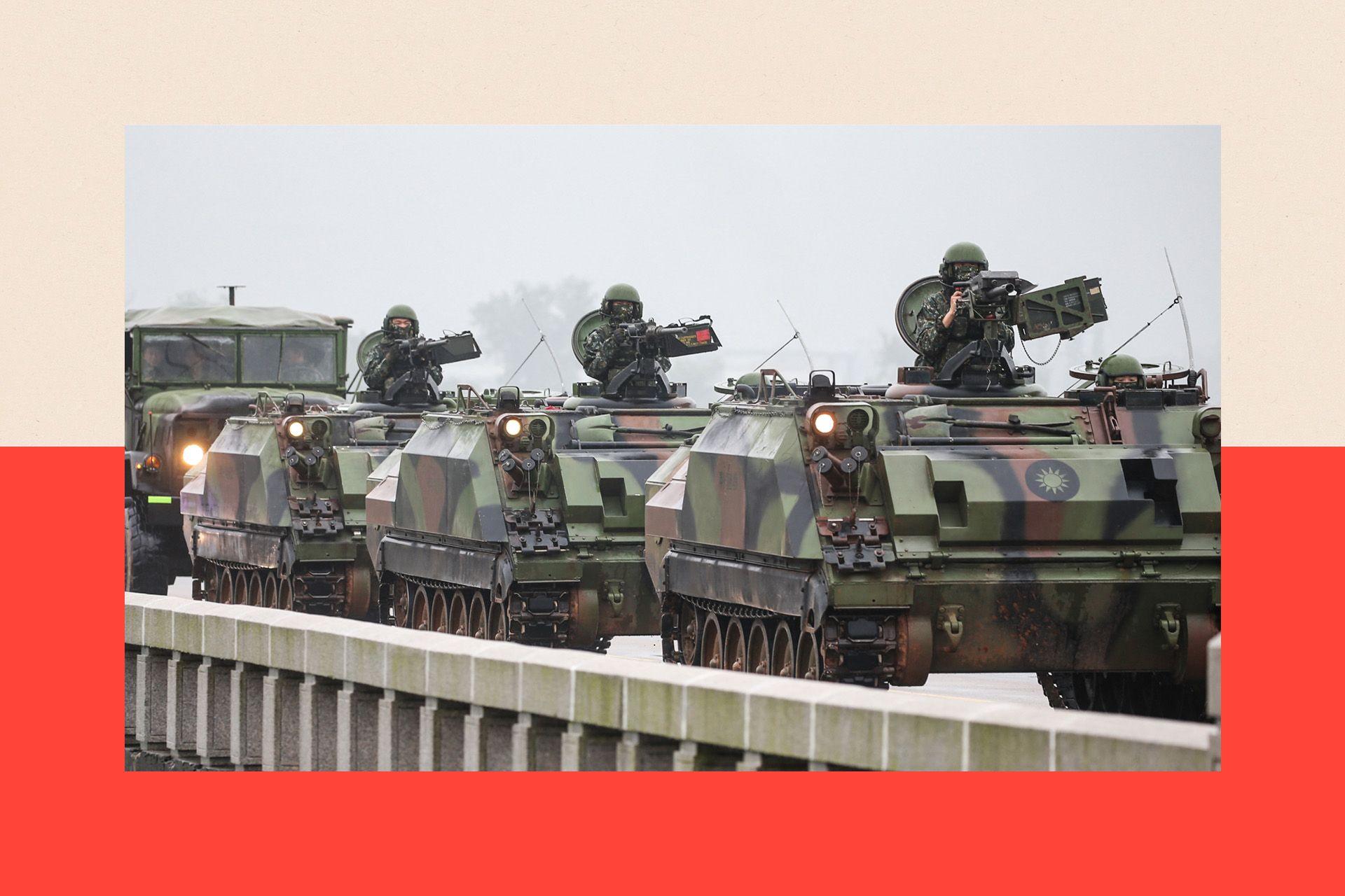 Taiwanese armoured vehicles roll down a street in Kinmen in May. There are three tanks and the sky is grey.