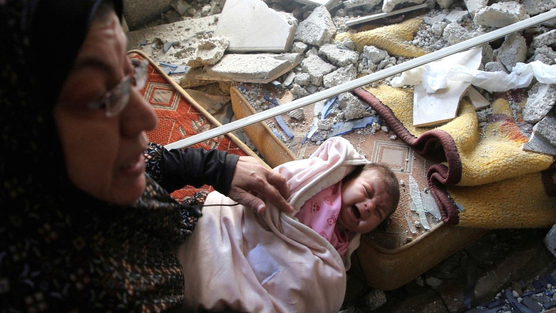 A Palestinian baby cries at a house damaged by an Israeli air strike in Rafah, in the southern Gaza Strip (29 April 2024)