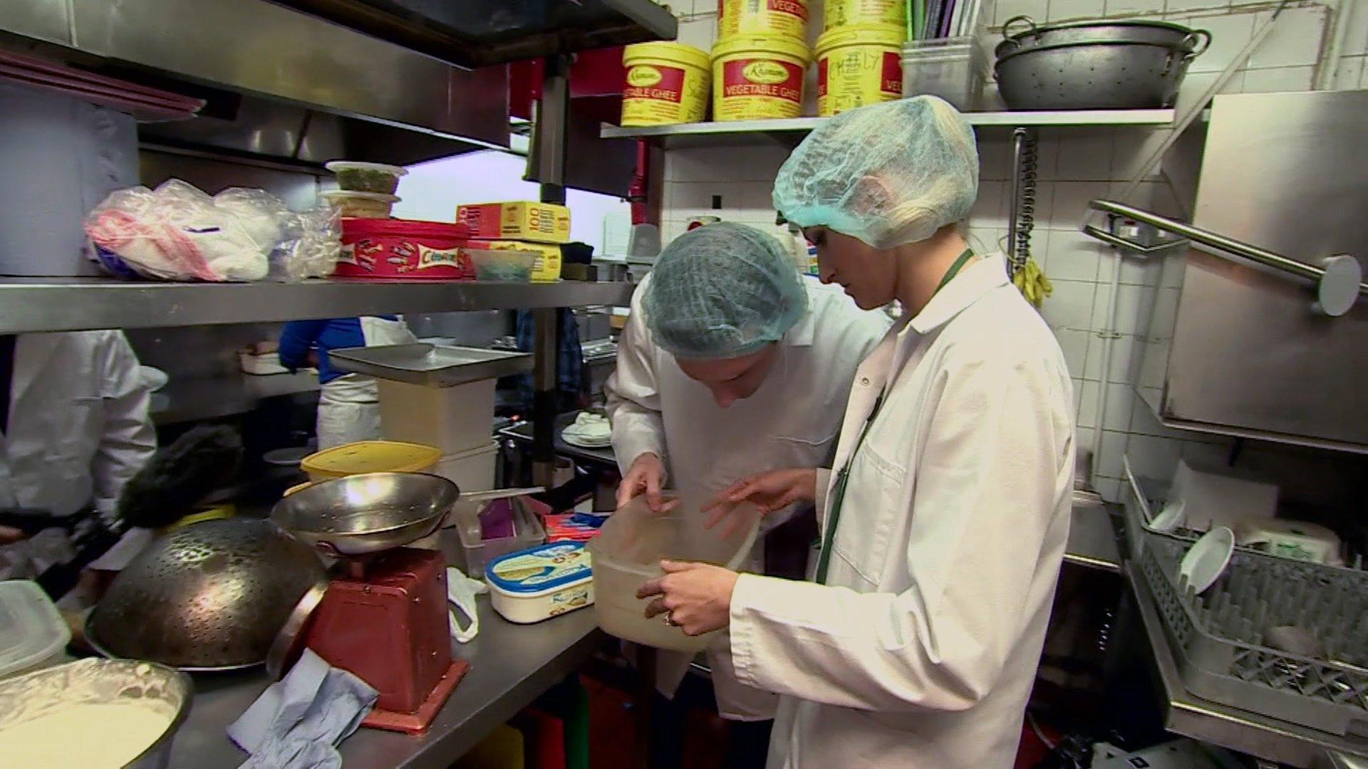 Food inspectors carry out an inspection of a restaurant