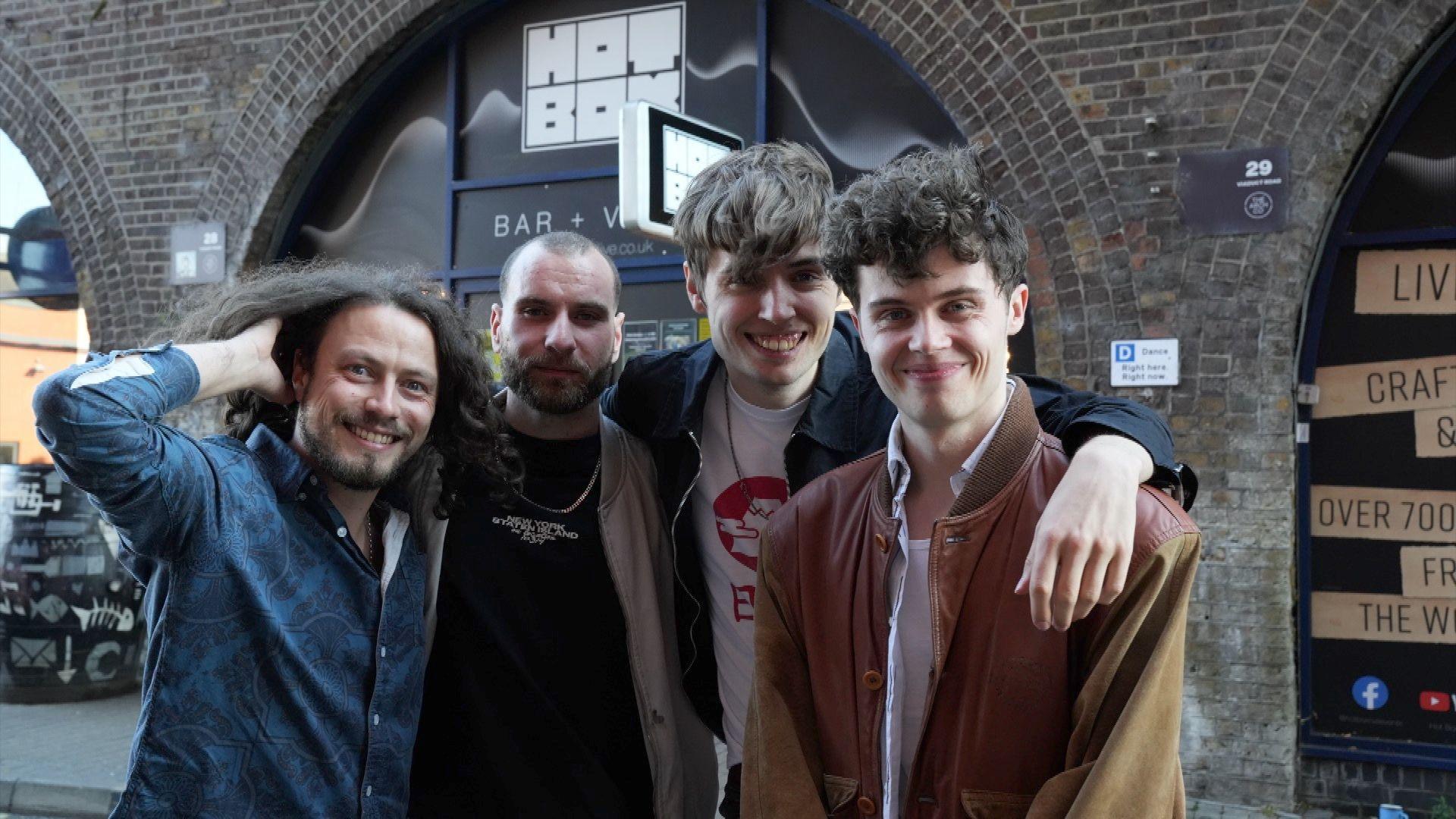 Four men standing outside the venue in Chelmsford. They are all smiling at the camera.
