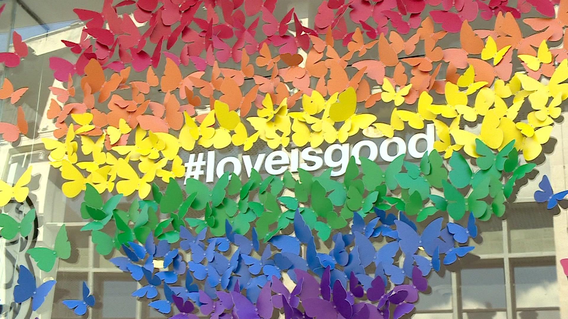 Pride inspired display with #loveisgood multi-coloured butterfly designed rainbow heart