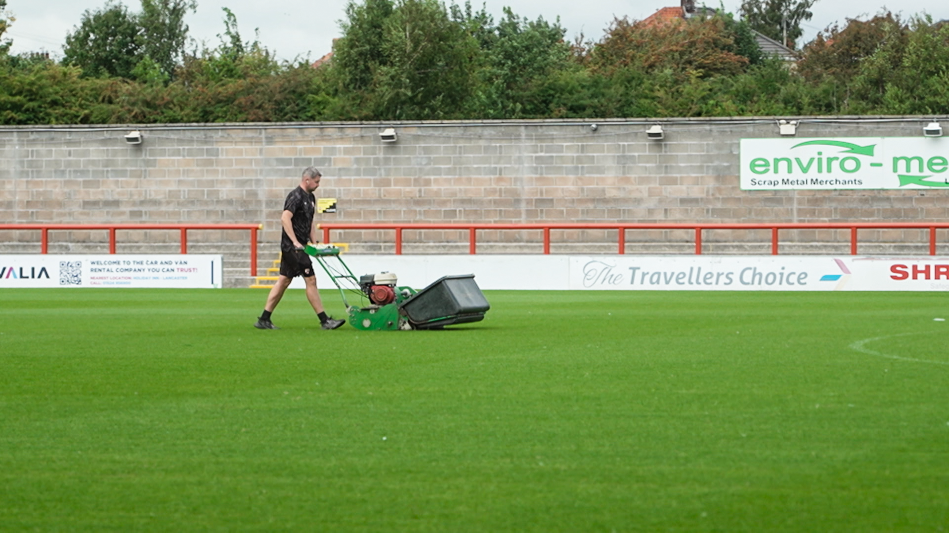 Morecambe's groundsman mows the stadium turf