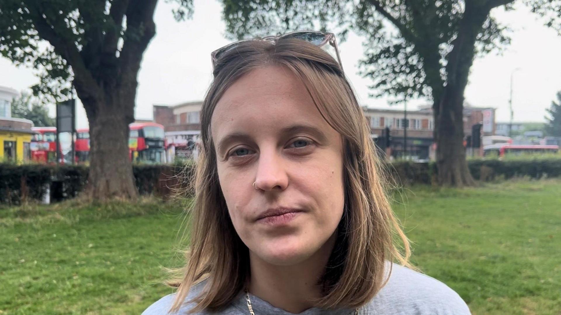 Dr Caitlin Clunie-O'Connor, a woman with short light hair wearing a grey jumper, on Ducketts Common near Turnpike Lane