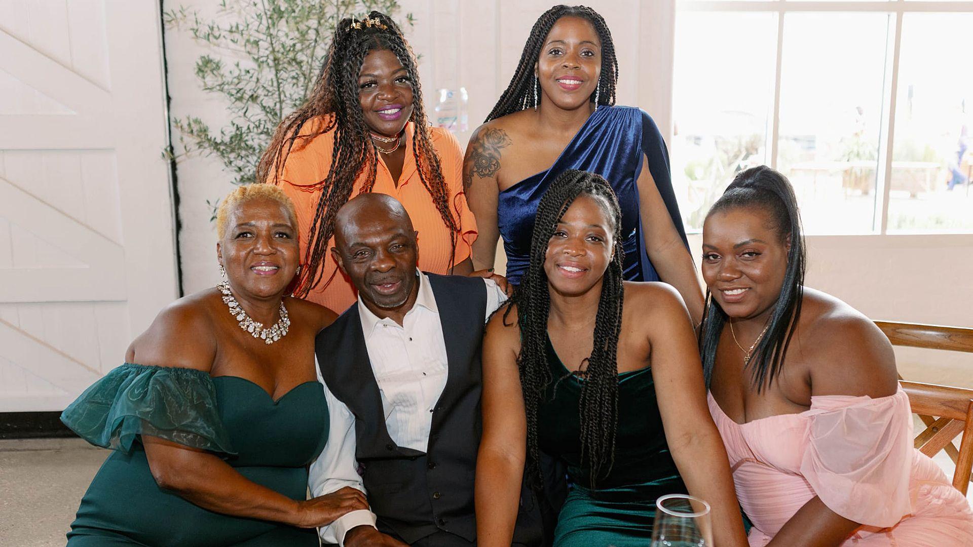 A family group shot of Carmen, James, Lisa, Keisha, Jamie and Patricia Cook in a restaurant.