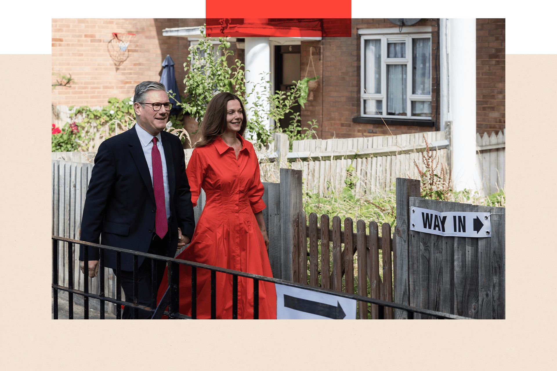  Sir Keir Starmer and his wife Victoria walk to a polling station to cast their votes. Ahead of them is a sign bearing the words "way in" and an arrow.