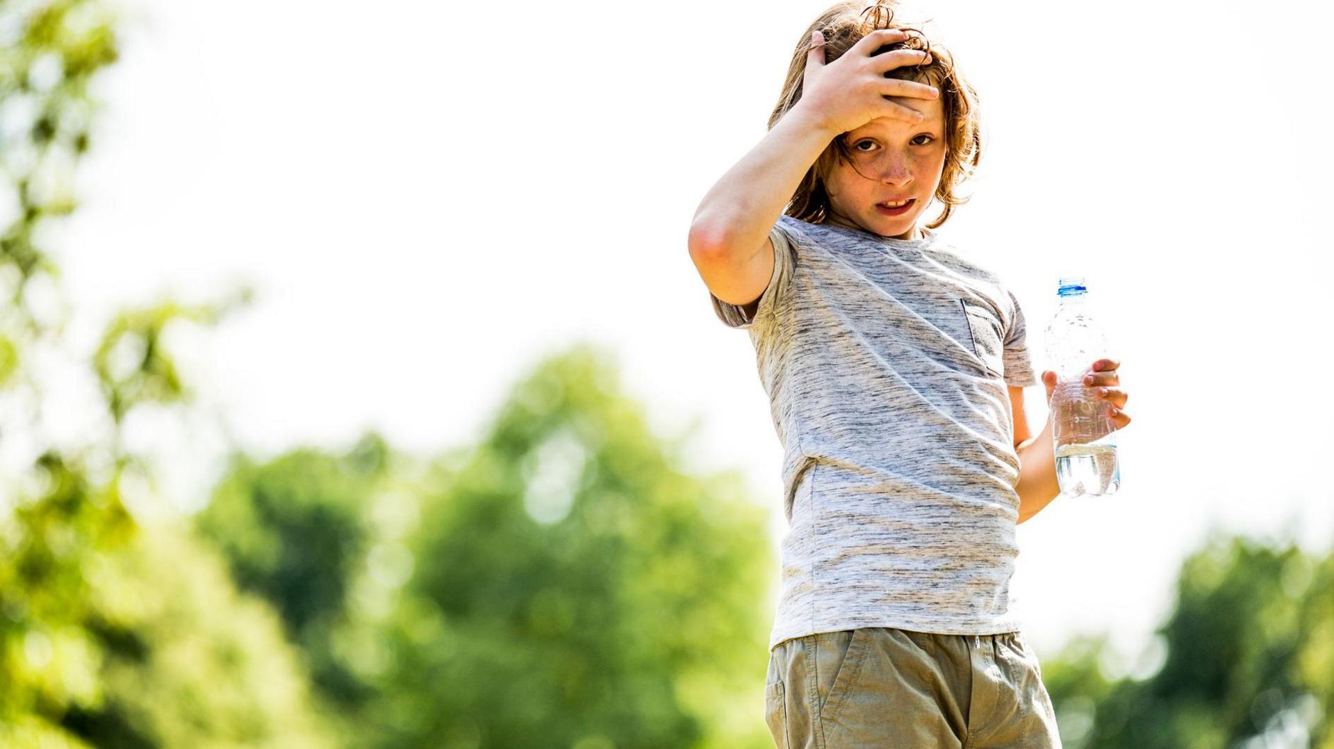 Boy holding a water bottle