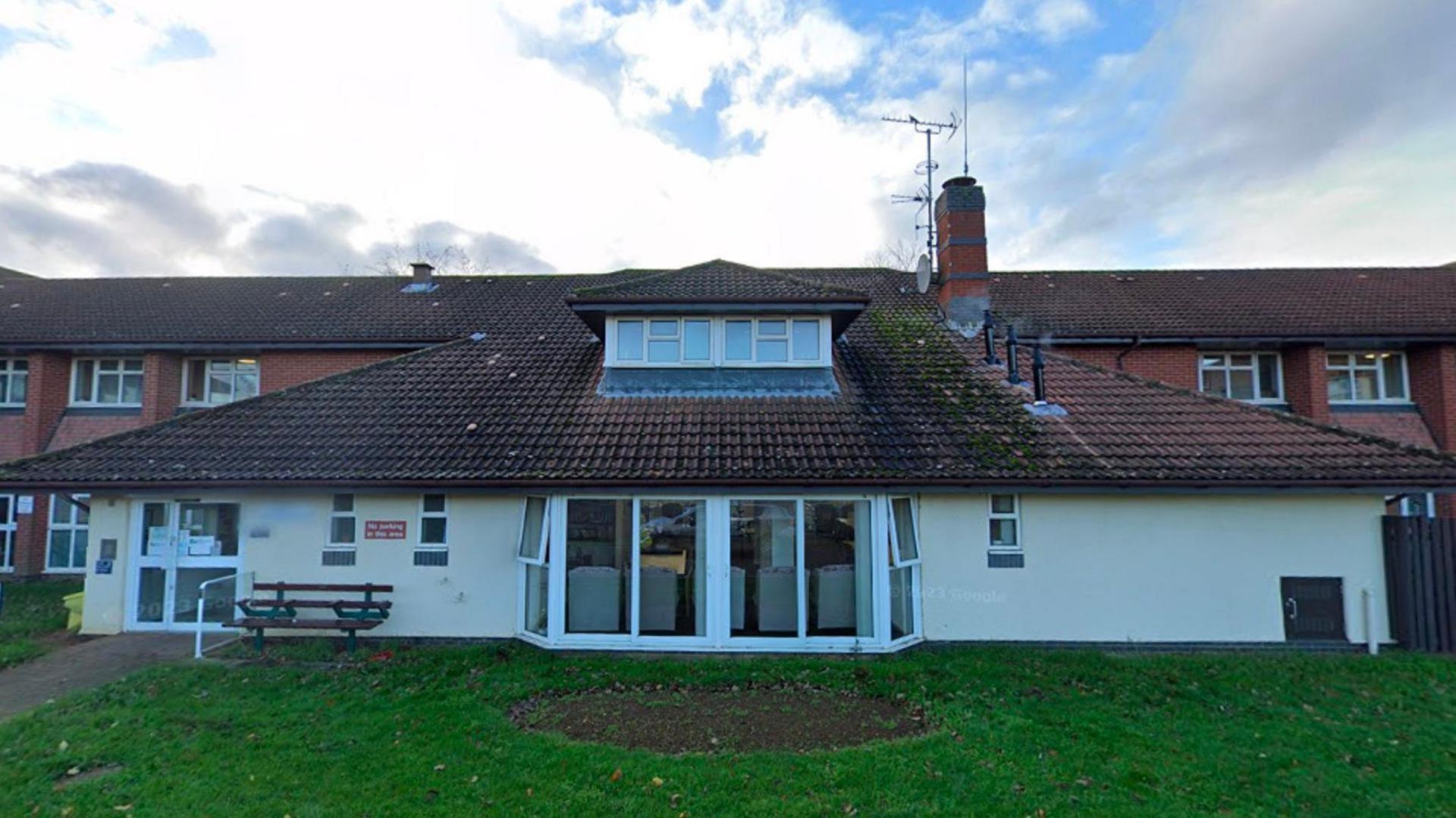 Single-storey entrance to sheltered housing scheme showing sloping tiled roof