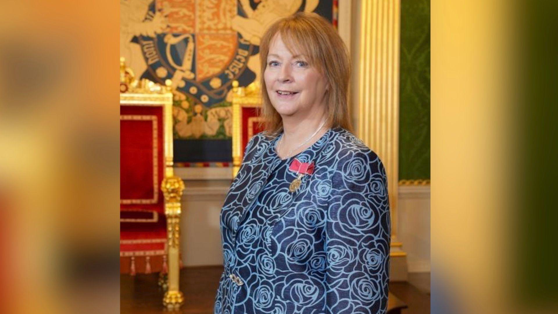 Ms Johnston was recently named on the new years honours list for her services to nursing - she is seen in a dark blue dress standing in the throne room at Hillsborough Castle with her British Empire Medal pinned to her chest.