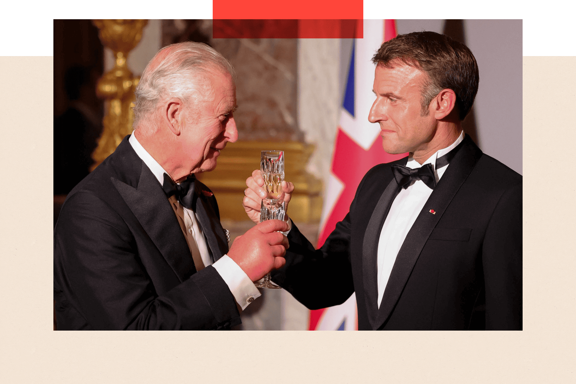 Macron and King Charles toast glasses, while looking happy and wearing black tie outfits