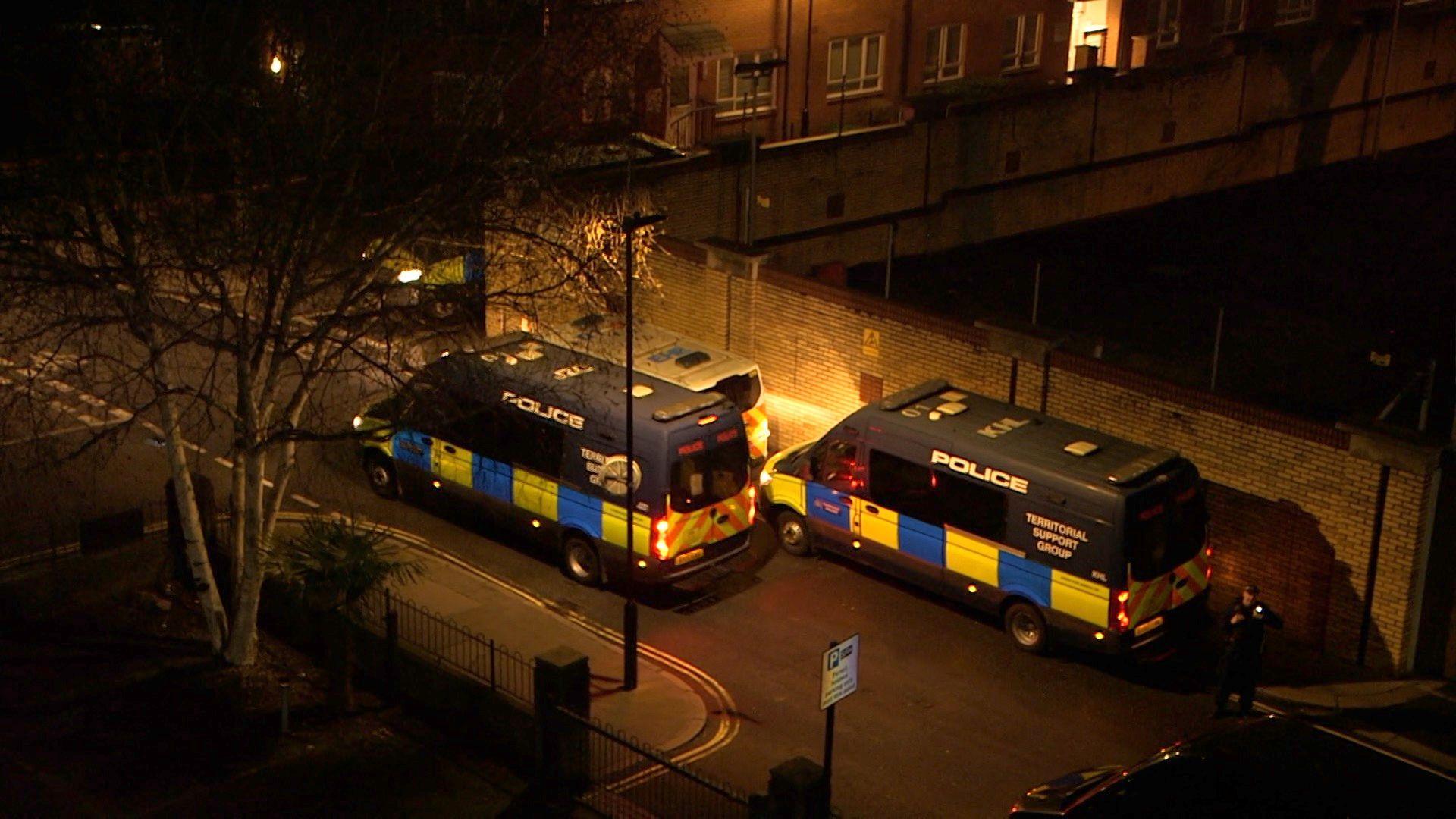 Police vans parked on a road