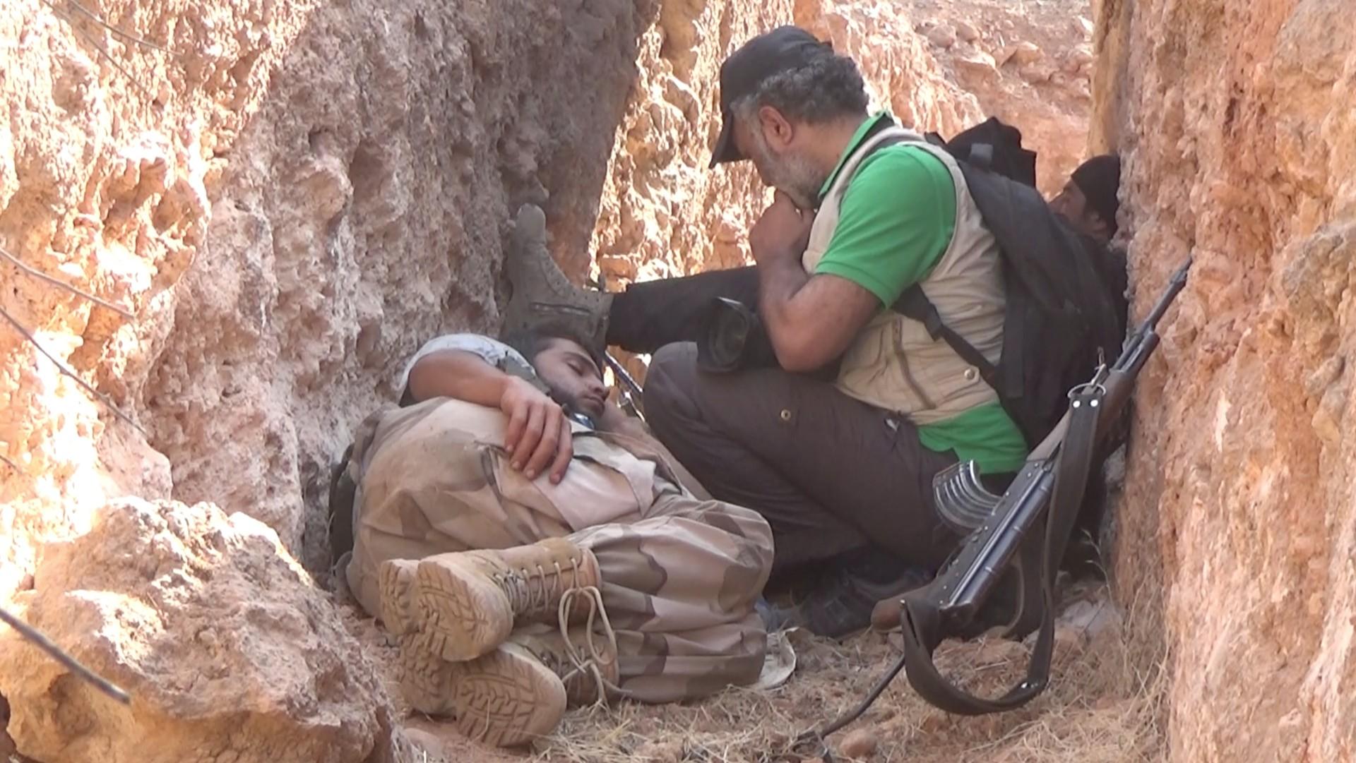 Abood Hamam with sleeping fighter in trench