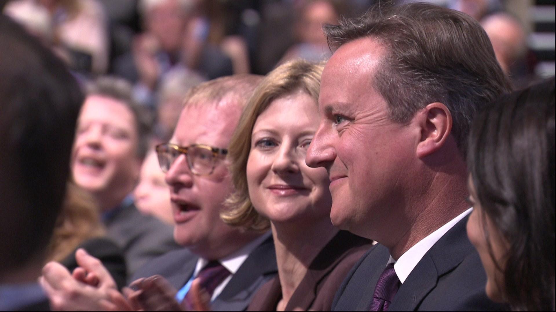 David Cameron listens to Osborne speech