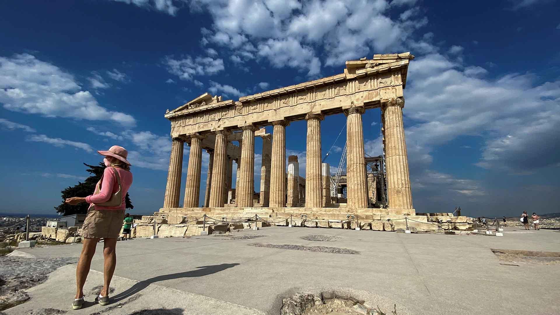 Tourist stands by the Parthenon in Athens