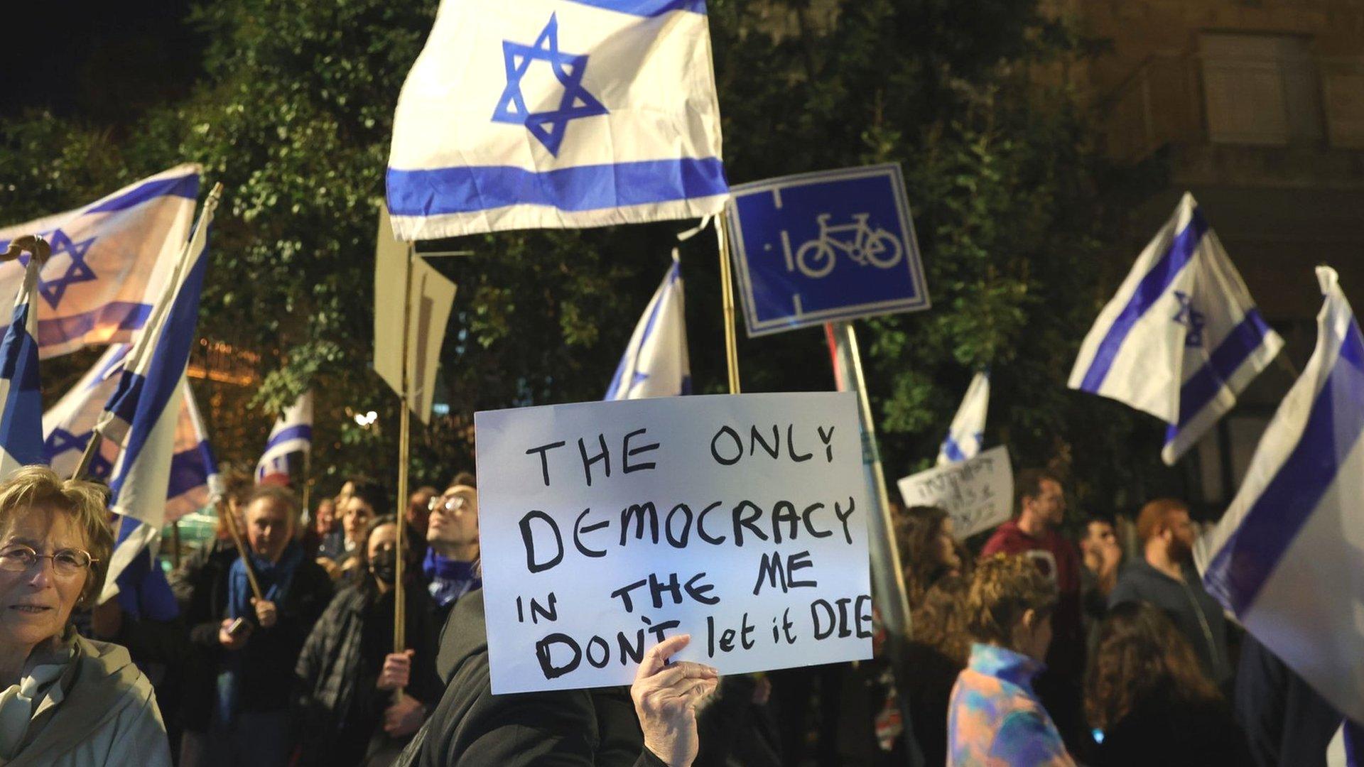 People protest against the Israeli government's judicial overhaul while leaders of the opposition and governing coalition meet at the president's residence in Jerusalem (28 March 2023)