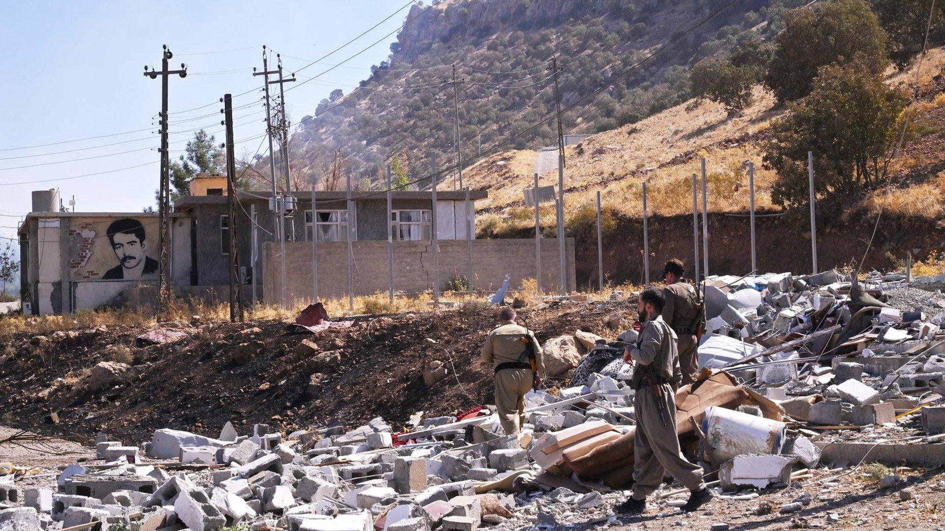 Iranian Komala party fighters inspect damage caused by Iranian Revolutionary Guards missile and drone strikes in Iraq's Kurdistan Region on 28 September 2022