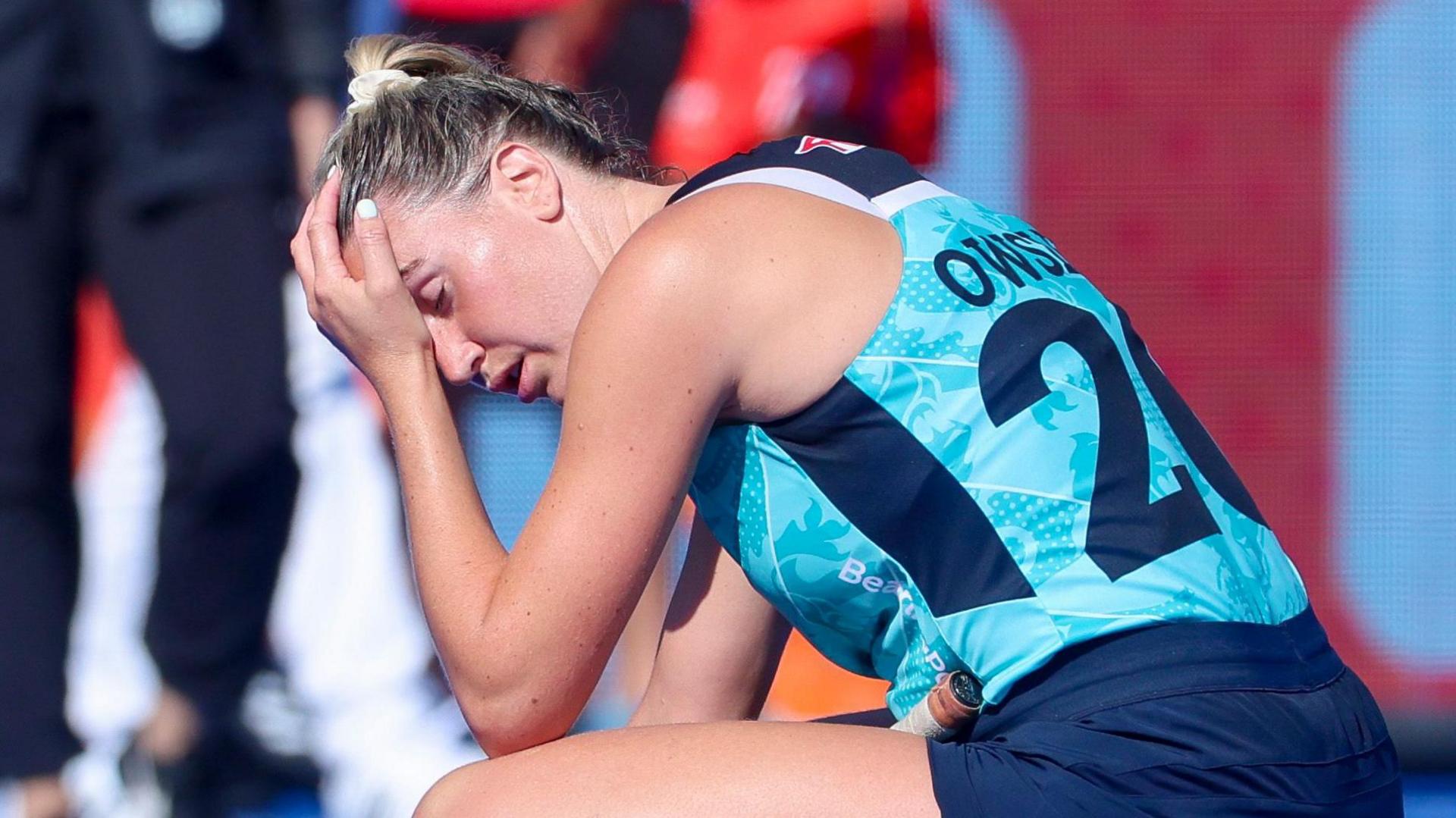 Lily Owsley of England crouched down with her head in her hands 