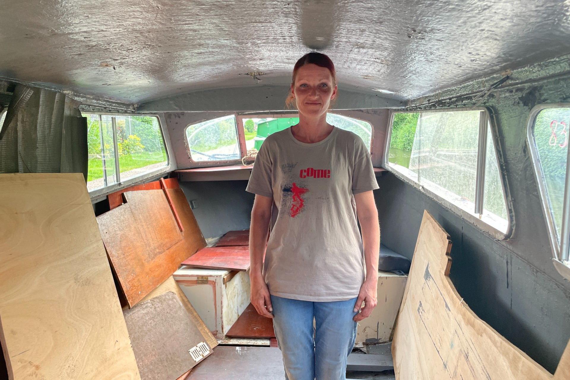 Jolita standing inside her boat