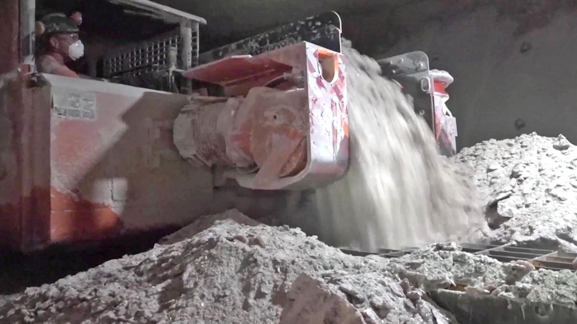 A man at work in Boulby Mine. The man is operating machinery which is cutting the salt in the mine. 