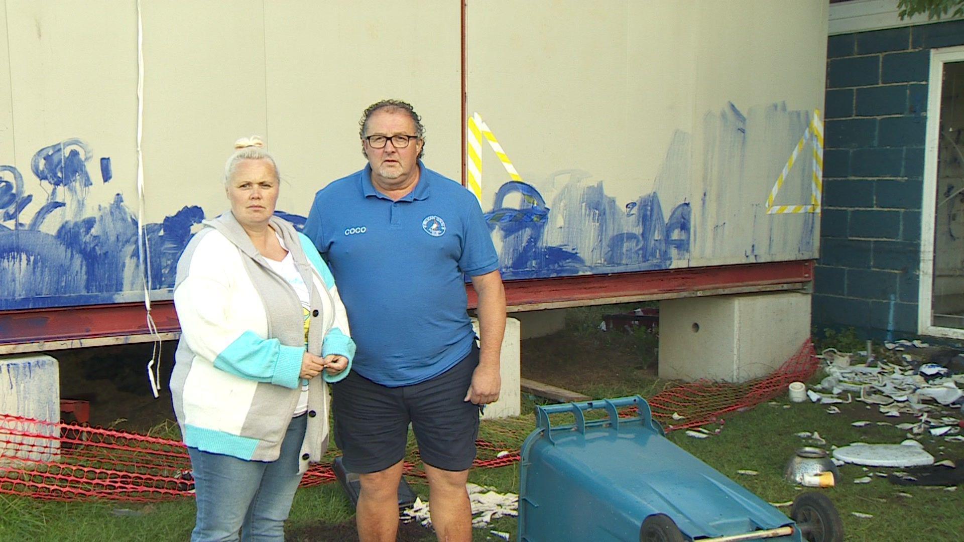 A photograph of volunteer Jemma Marriott and chairman Steve Chaplin standing in front of a vandalised changing room