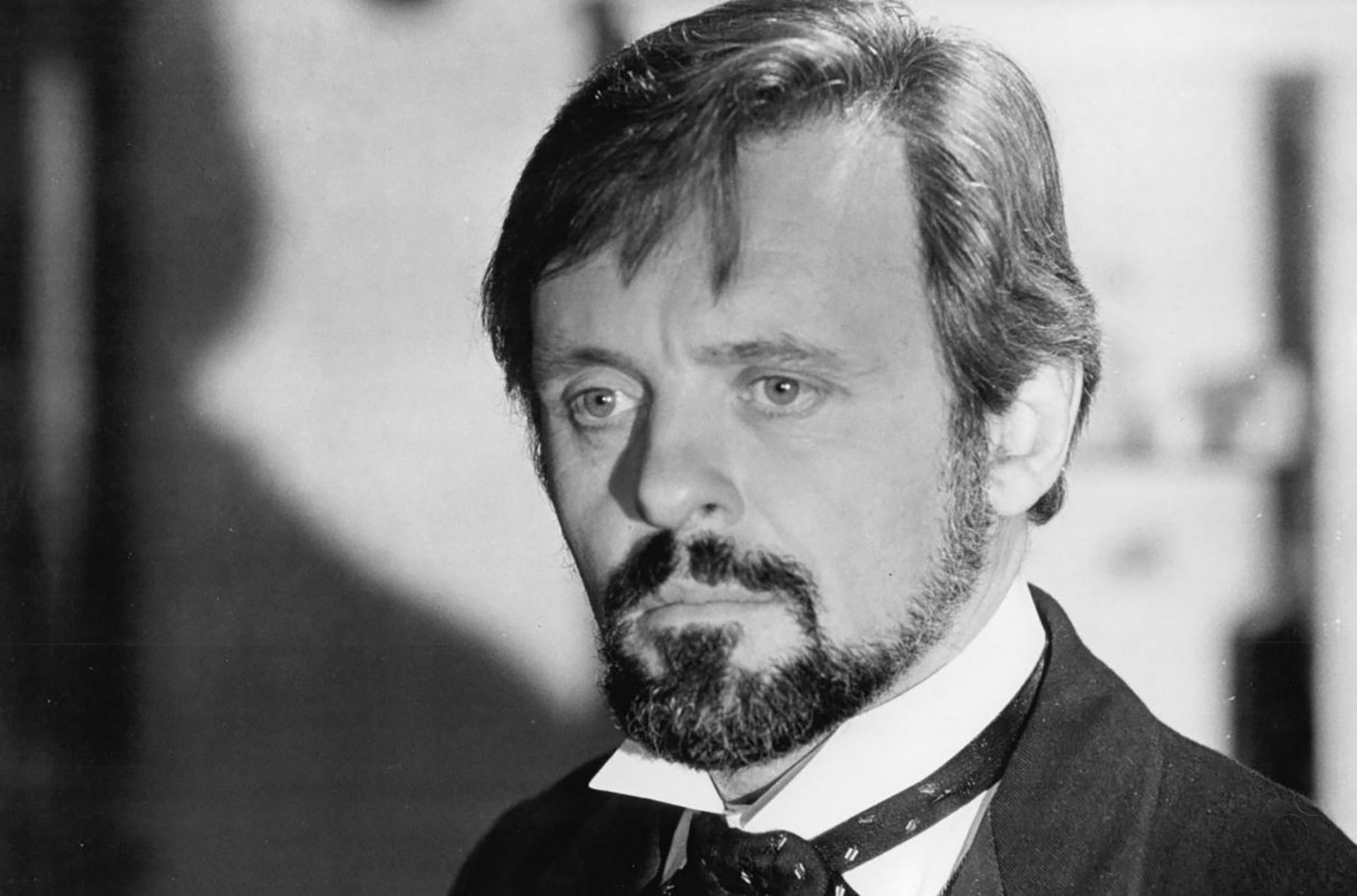 Black and white photo of Sir Anthony as Dr Treves looking unsmilingly to camera with moustache and beard, white collar and cravat
