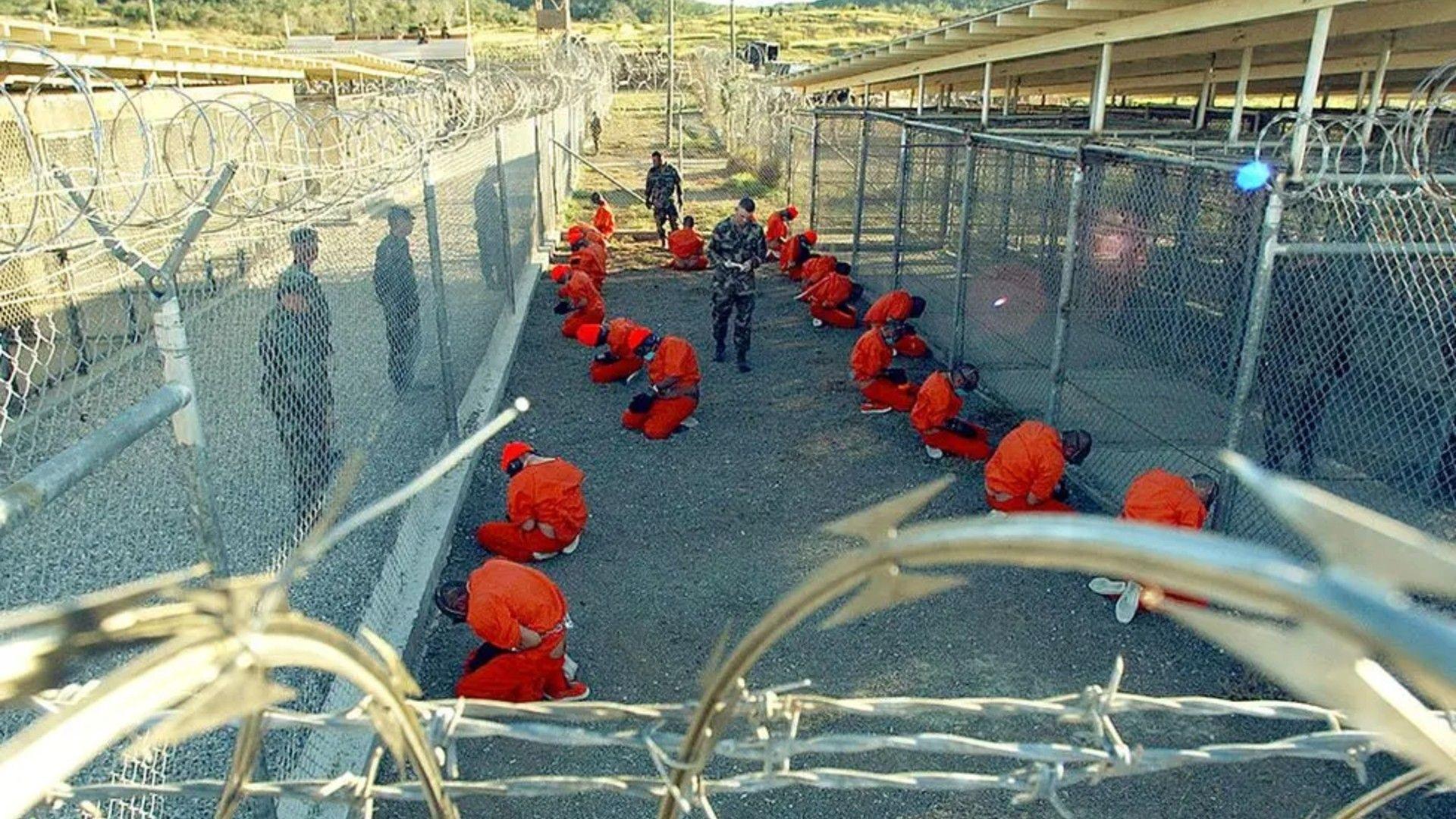 Detainees in orange jumpsuits at the Guantanamo Bay detention camp, in January 2002