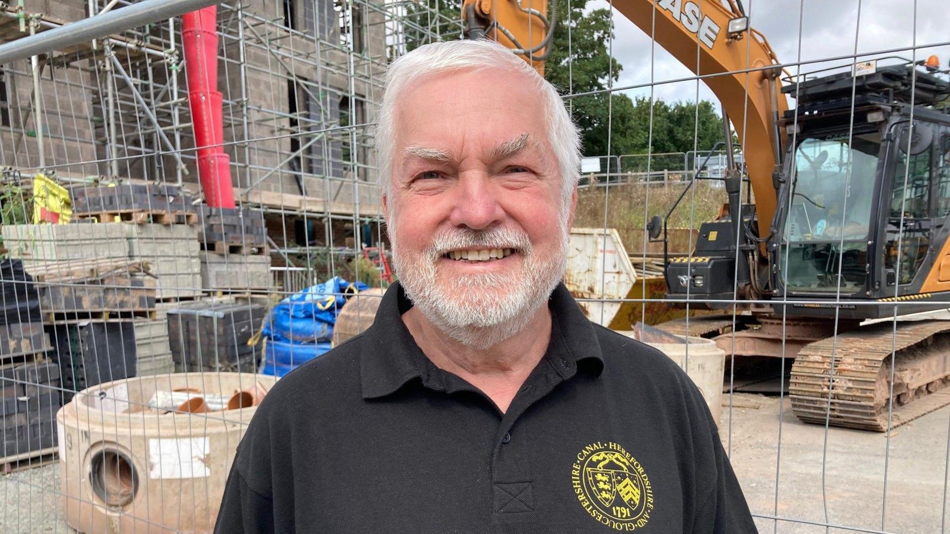 Tony Higgins from the canal trust in front of the building site 