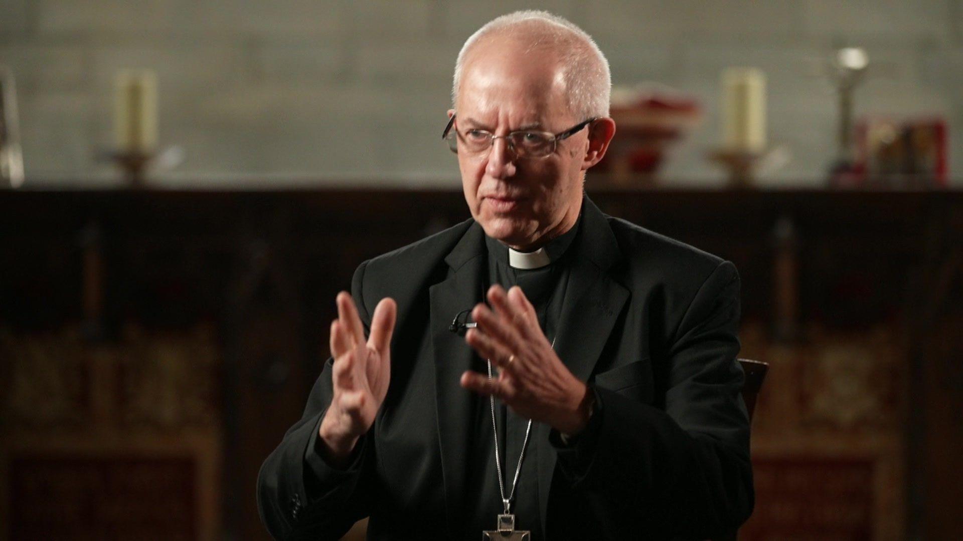 Justin Welby wearing a black blazer, glasses and clerical collar