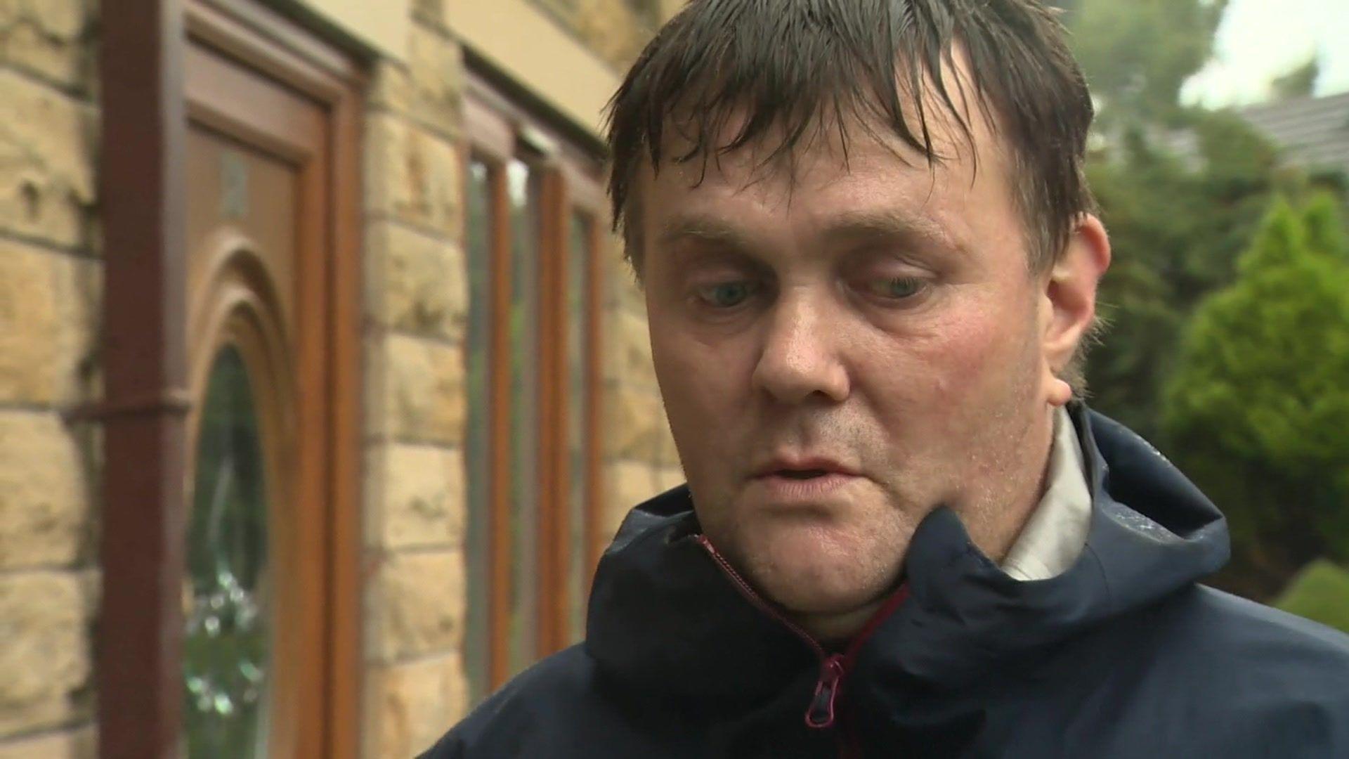 Lee Brown, standing outside a house in Ashley Court in Accrington, describing how he tried to stop an XL Bully dog attacking his friend David Daintree