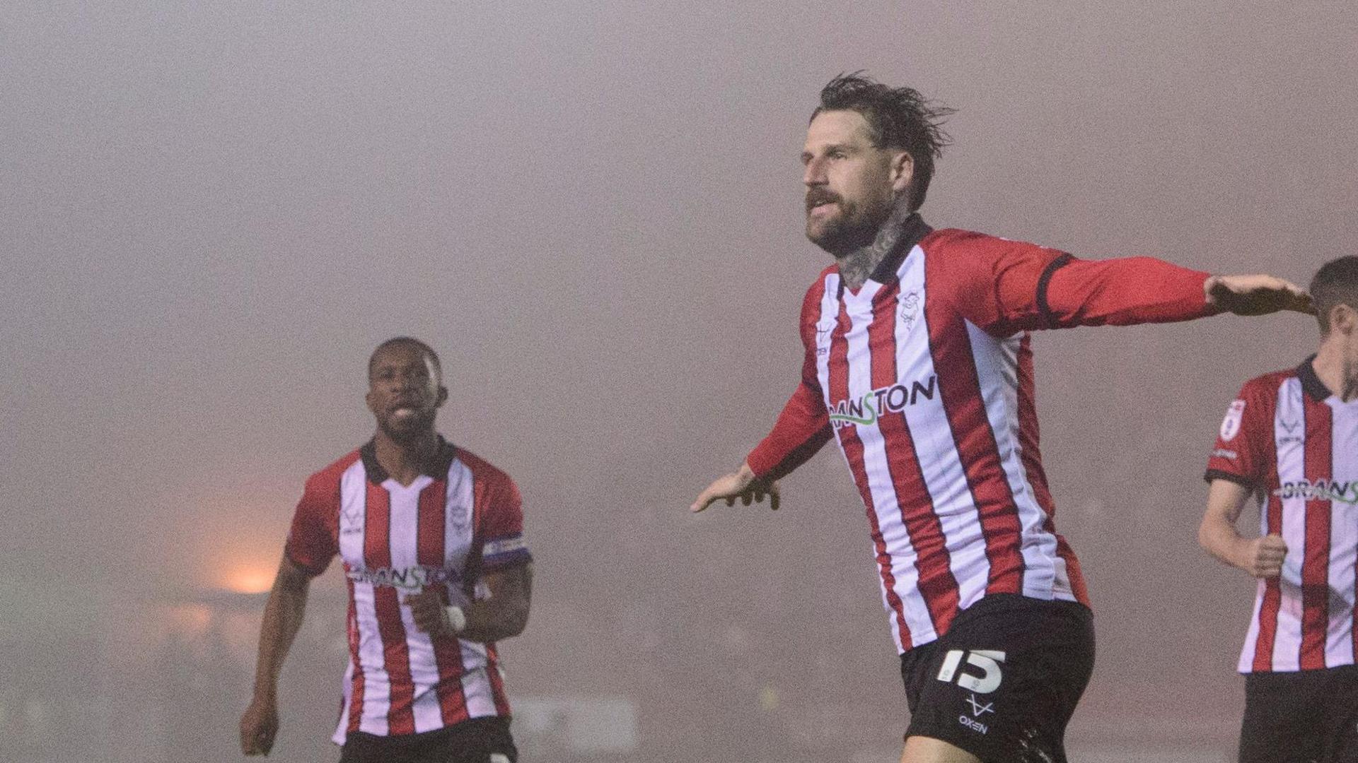 Sonny Bradley celebrates scoring Lincoln's winning goal against Cardiff City