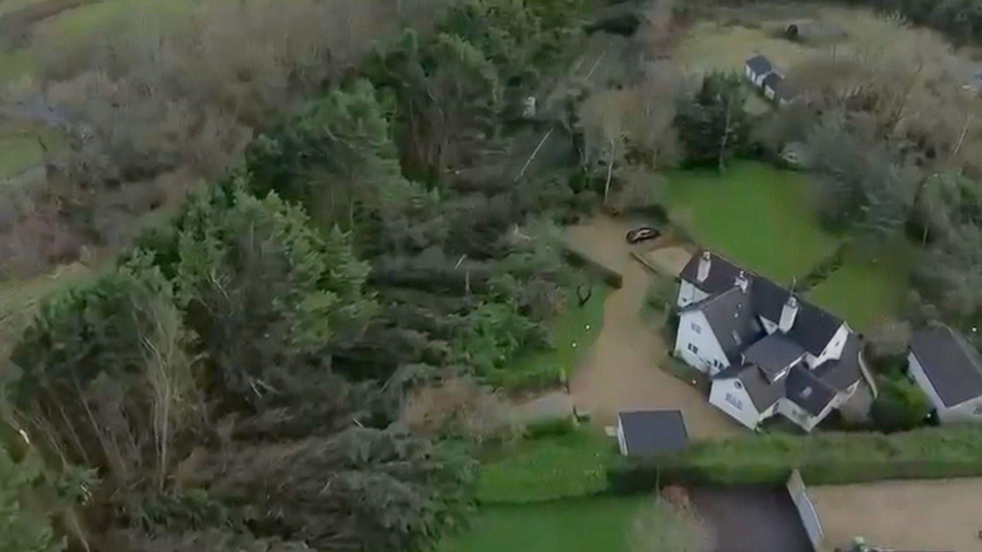 Aerial shot of trees falling down in Bourton on the Water trapping in houses. 