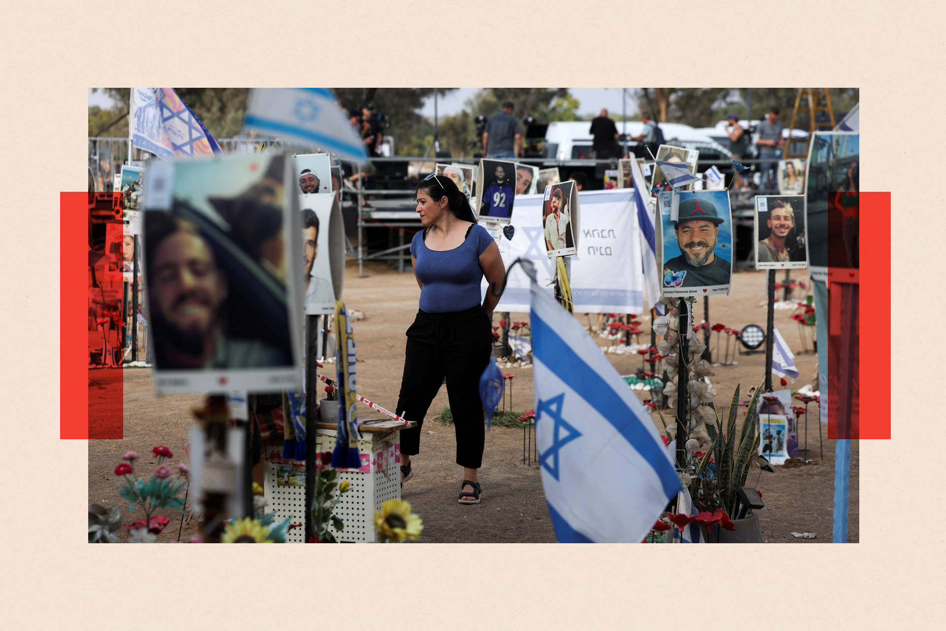 A woman stands among tributes at the Nova festival site, honouring victims who were killed or kidnapped on October 7. The area is surrounded by photos and flowers