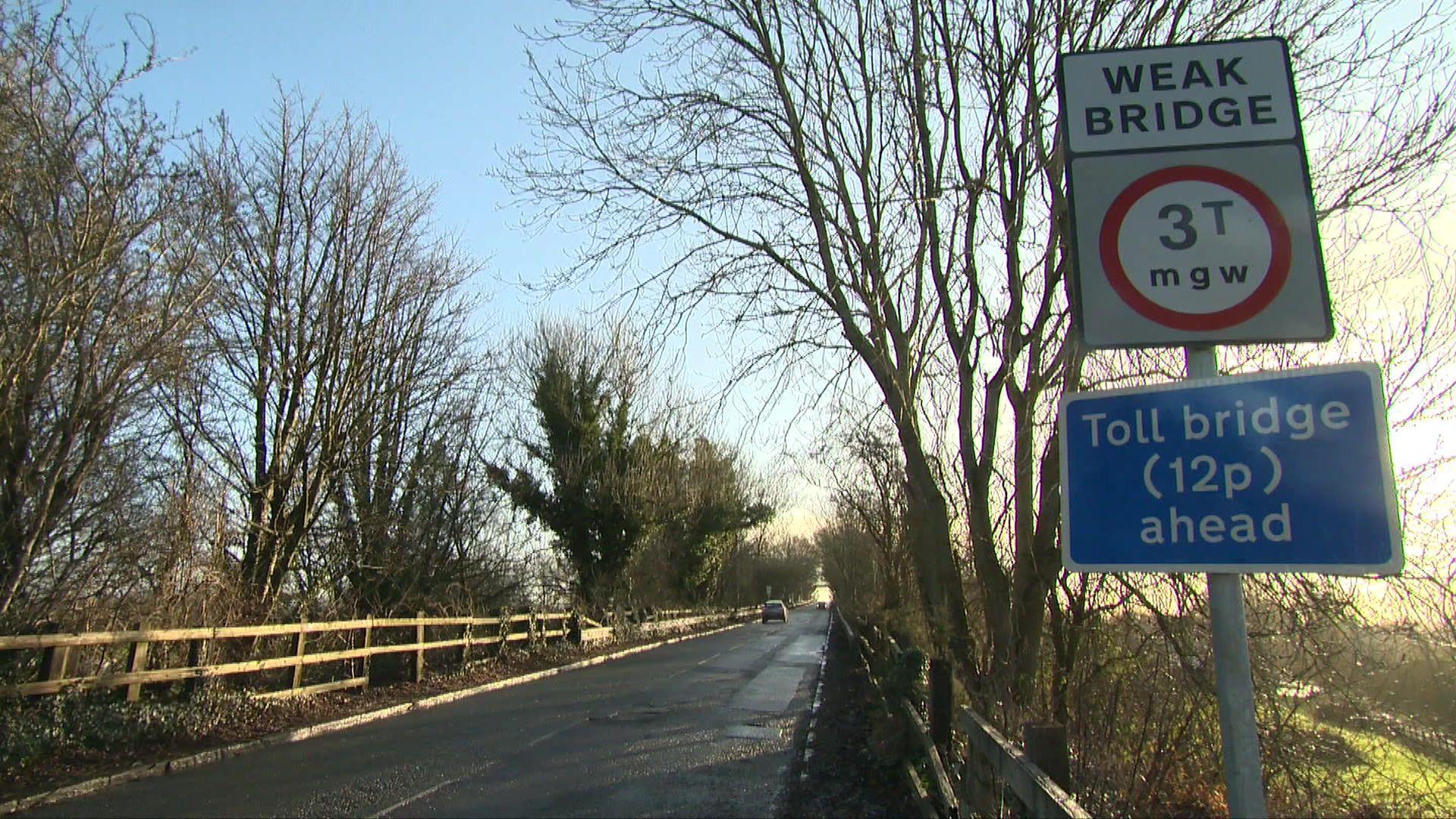 A view of the Warburton Toll bridge with the 12p sign in front