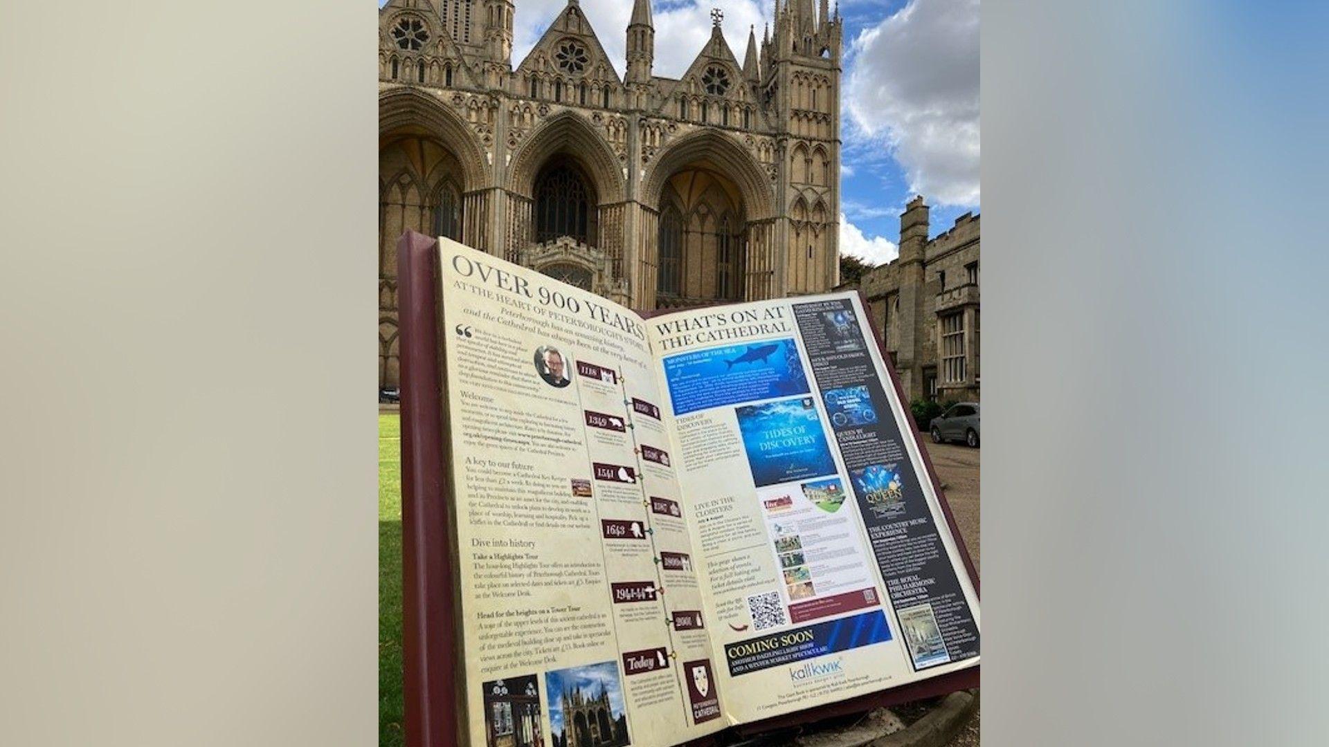 A large sculpture of an open book outside the cathedral's entrance, which tells visitors about the history of the site and what exhibitions are on.