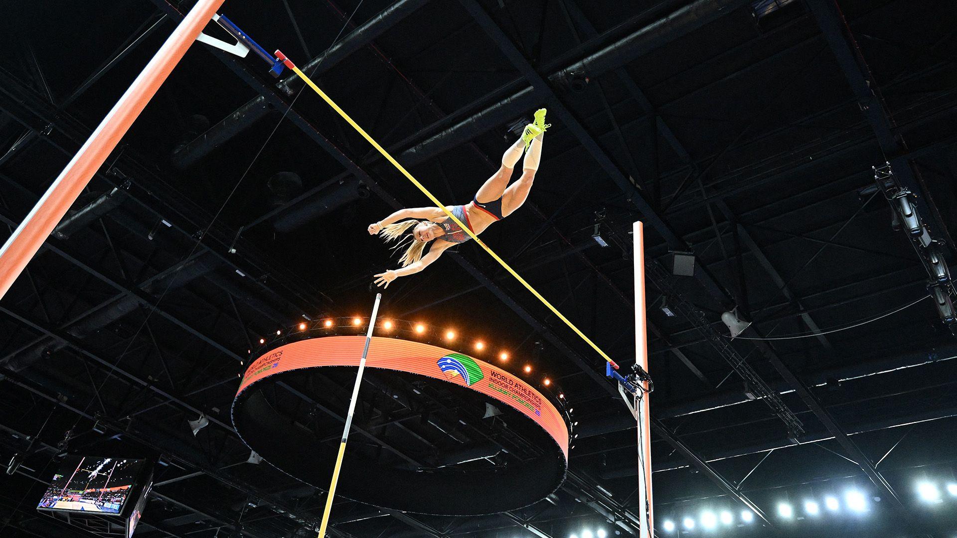 Molly Caudery is mid air as she clears the pole. 