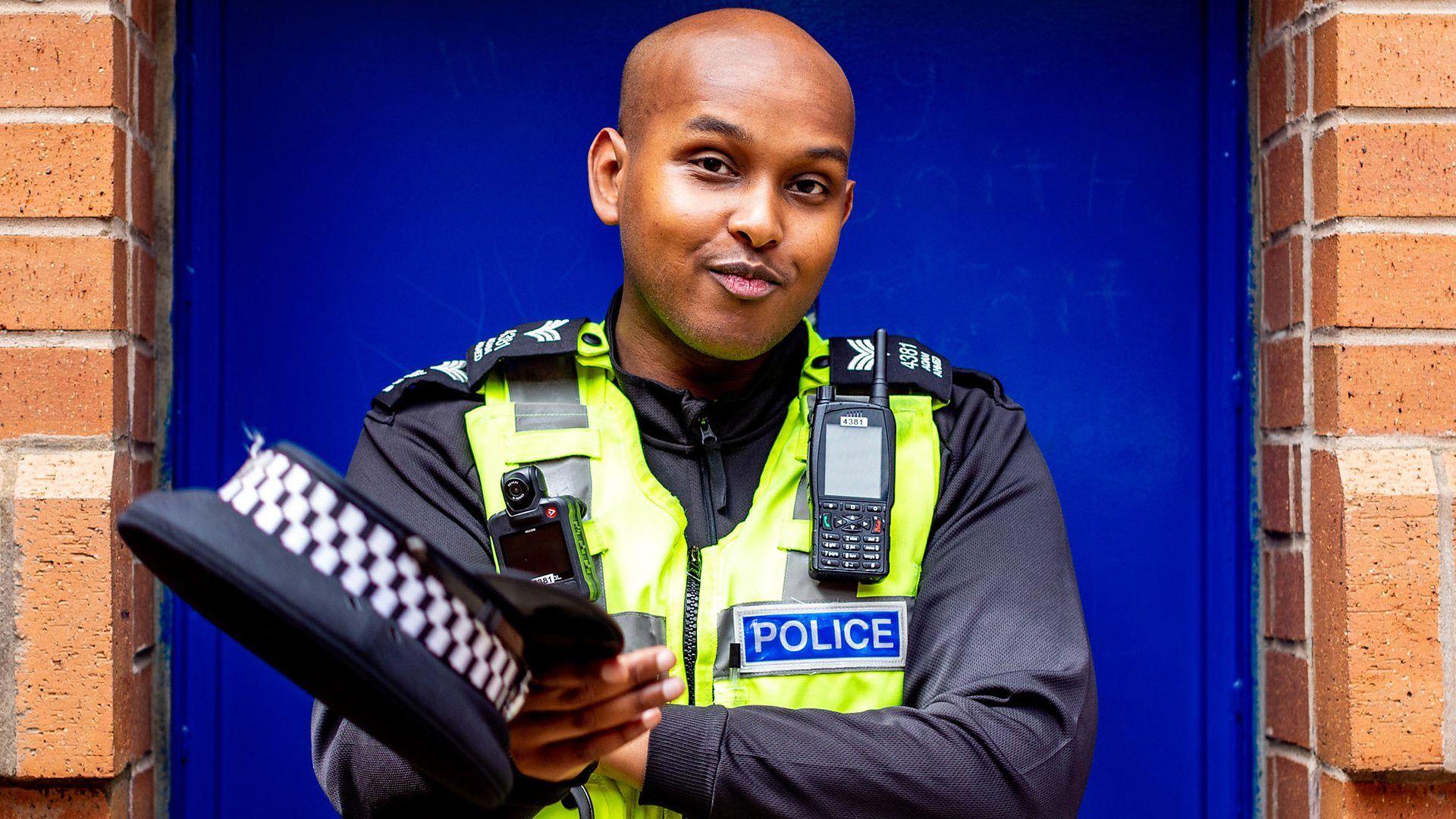 Sgt Ahmed is holding his police cap