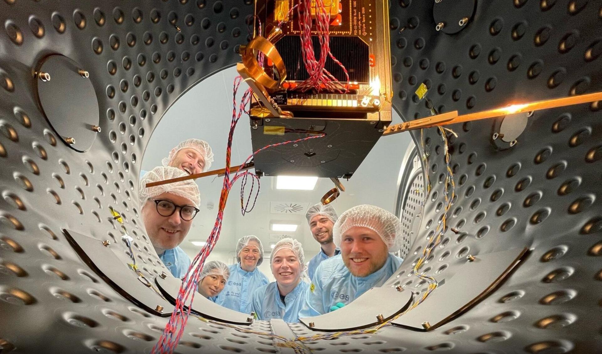 EIRSAT-1 researchers with satellite 